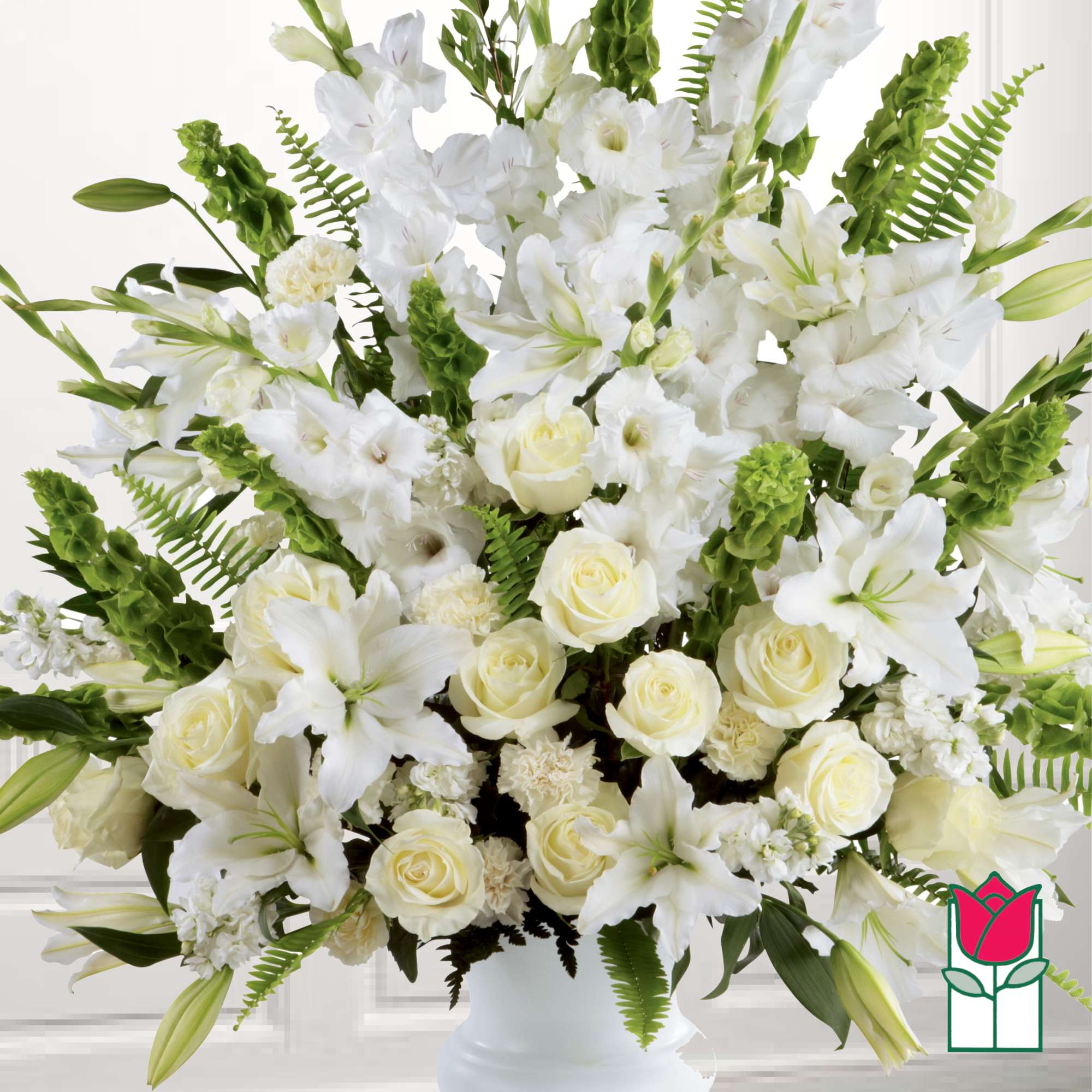 White lilies and roses arranged in a white vase