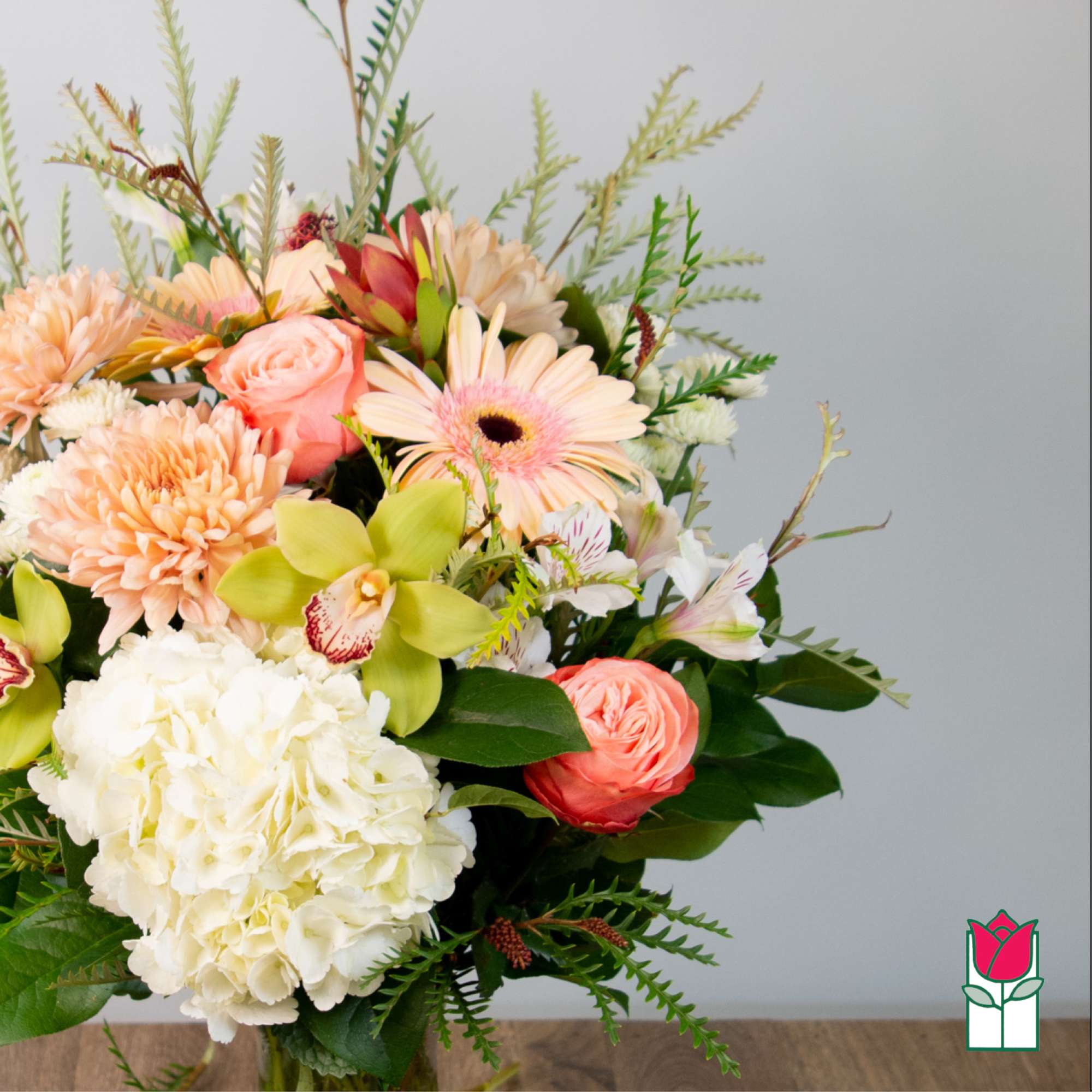 Bouquet of peach and white flowers with green accents