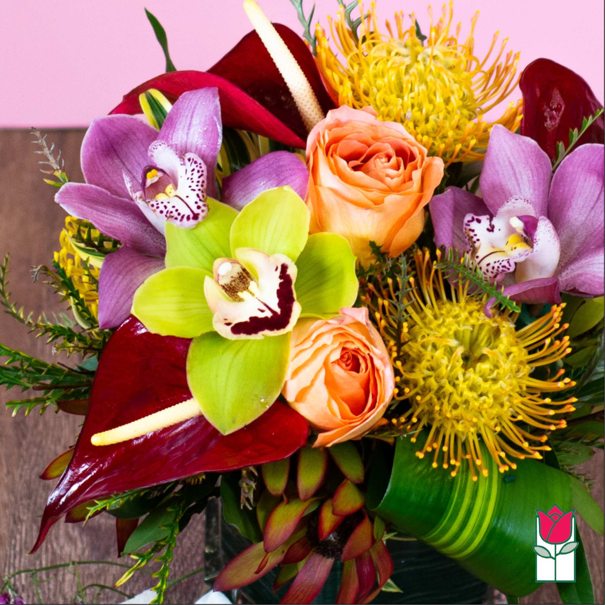 Bouquet with purple orchids, peach roses, and yellow tropical blooms