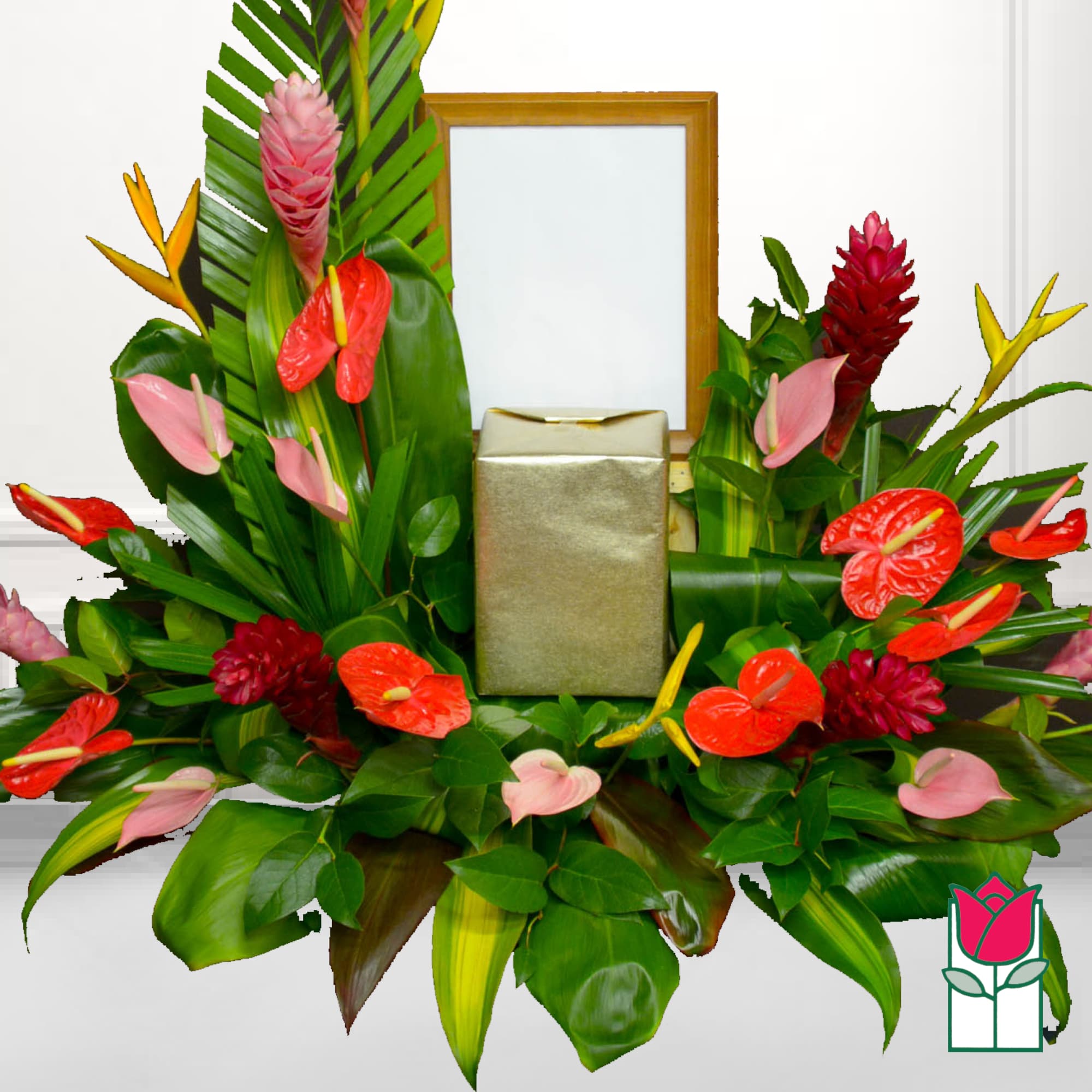 Tropical floral arrangement with red and pink anthuriums around a gold gift box