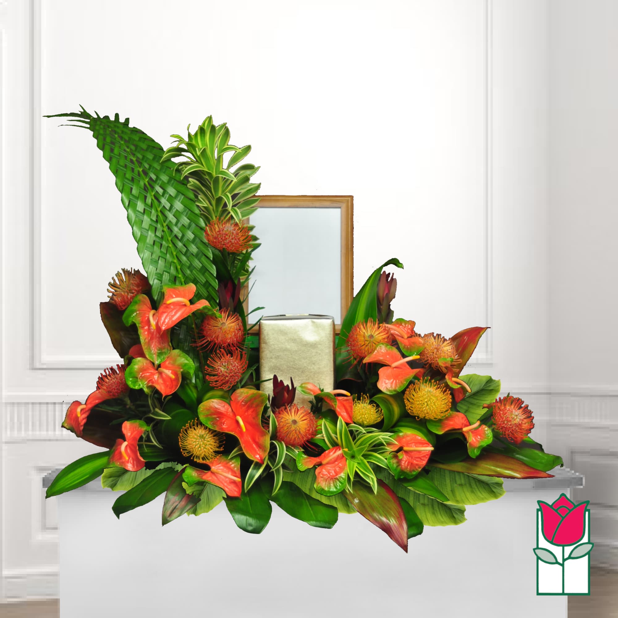 Tropical floral arrangement with orange anthuriums and a gold box centerpiece