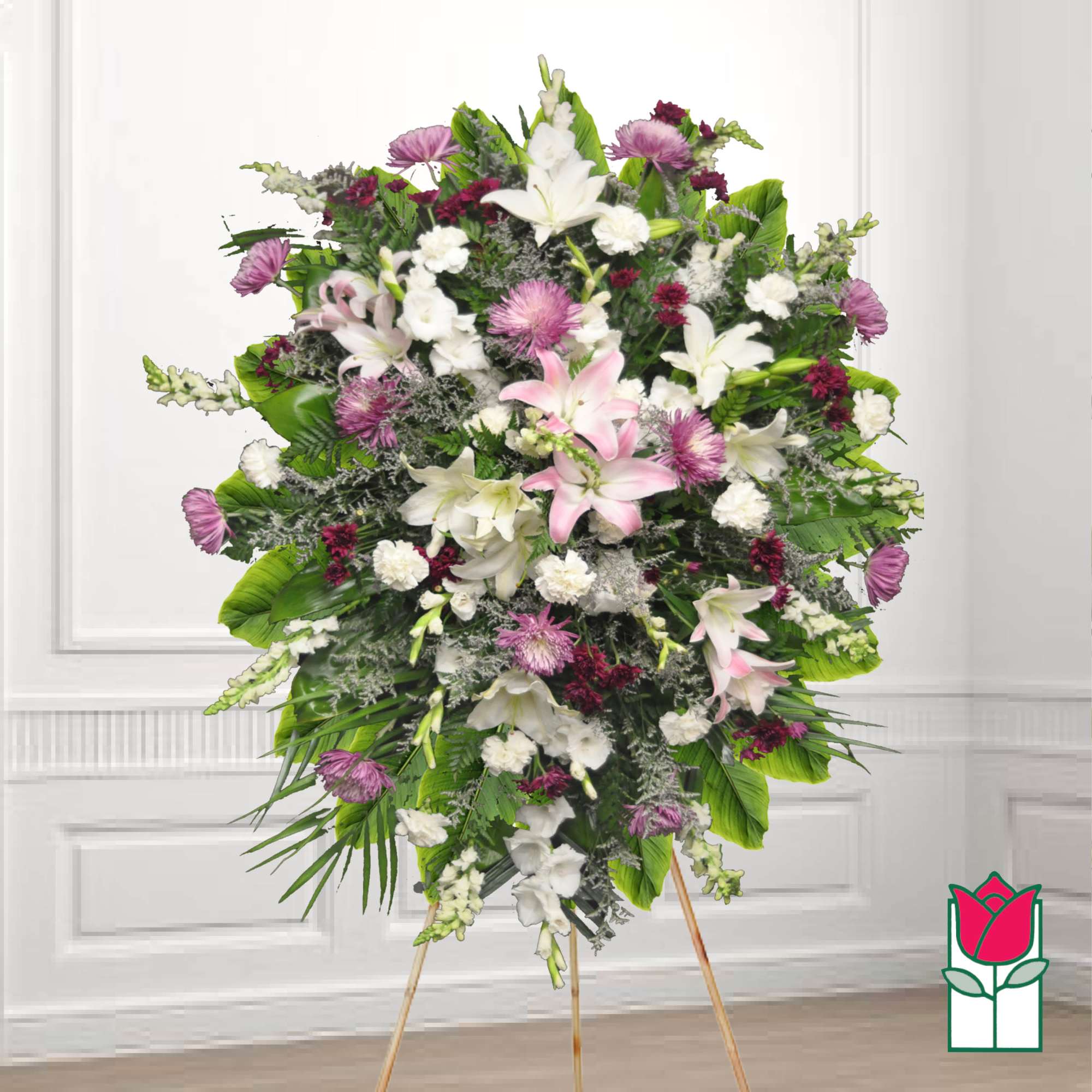 Large standing floral spray with pink and white lilies and purple accents