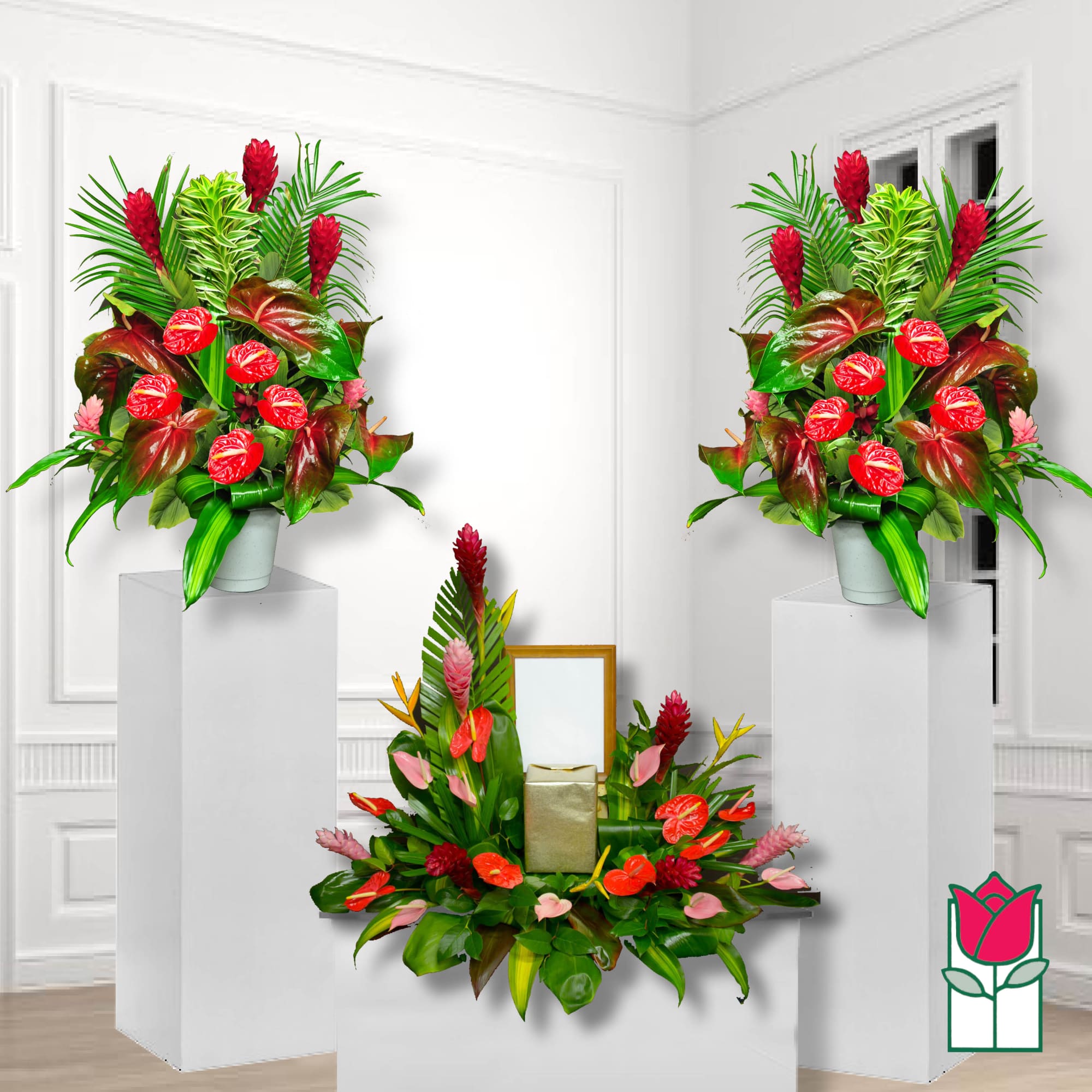 Tropical floral arrangements with red anthuriums and pink blooms in white containers