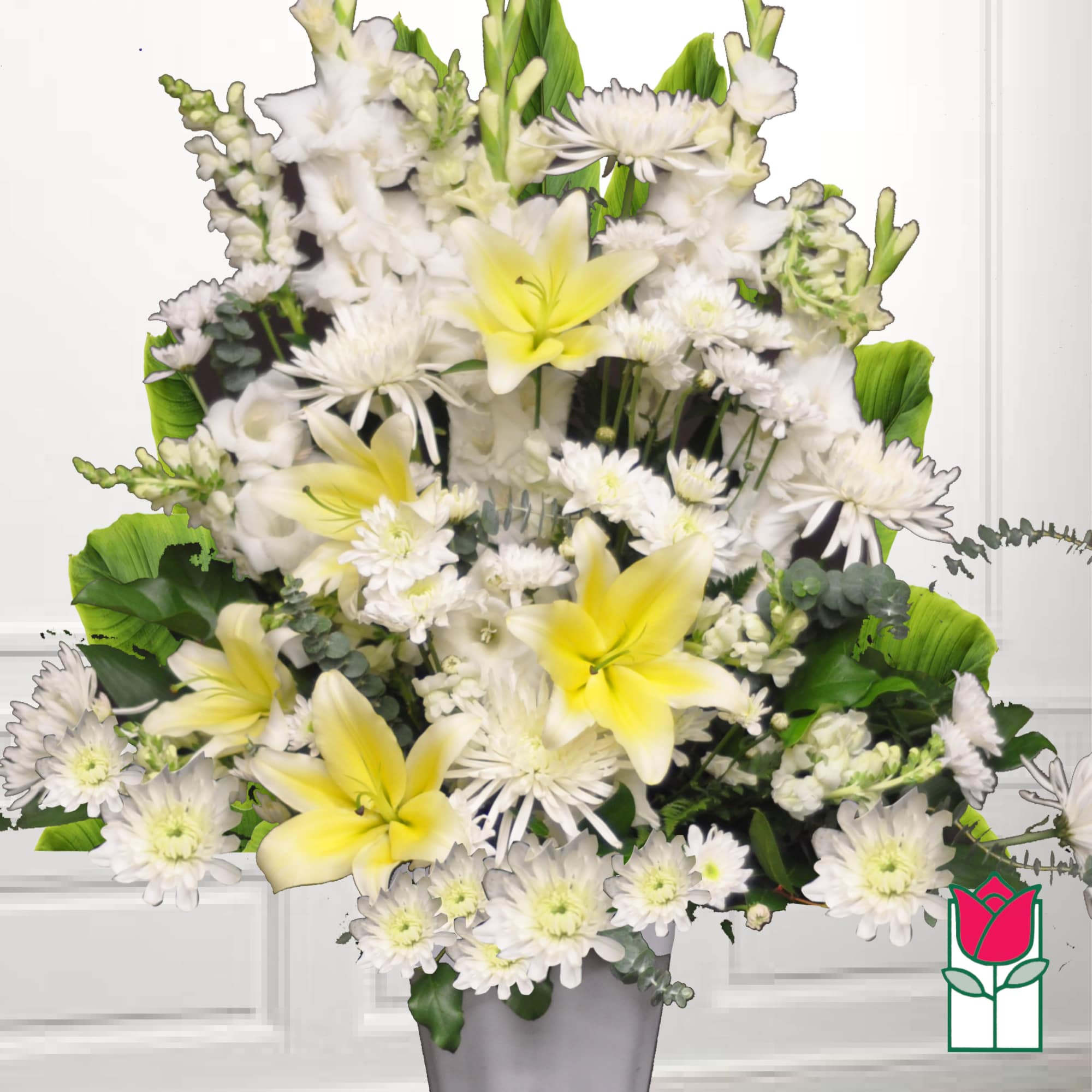 White and yellow floral arrangement in a gray vase