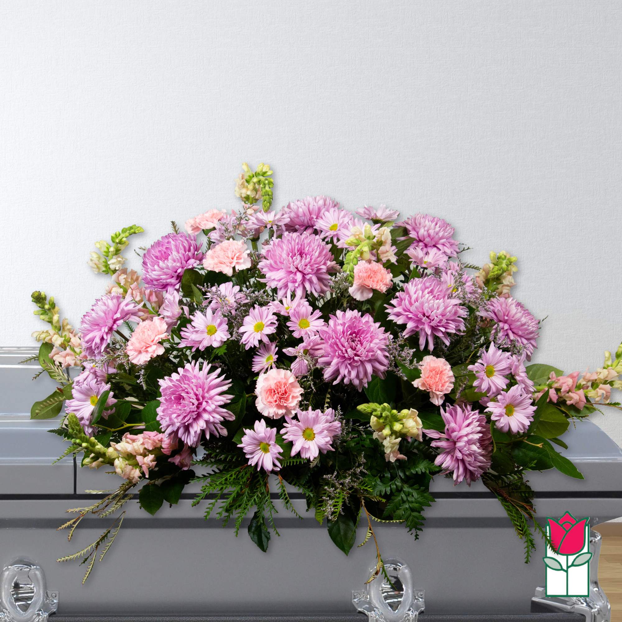 Pink and lavender flowers arranged on a casket