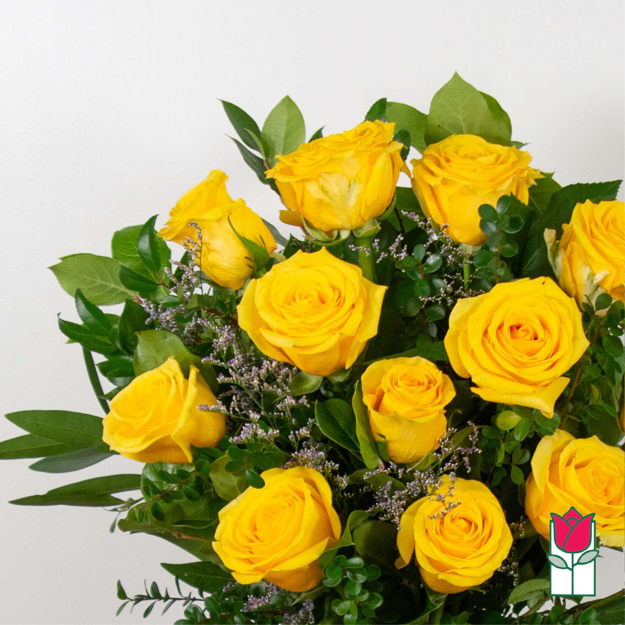 Bouquet of yellow roses with greenery and small purple filler flowers