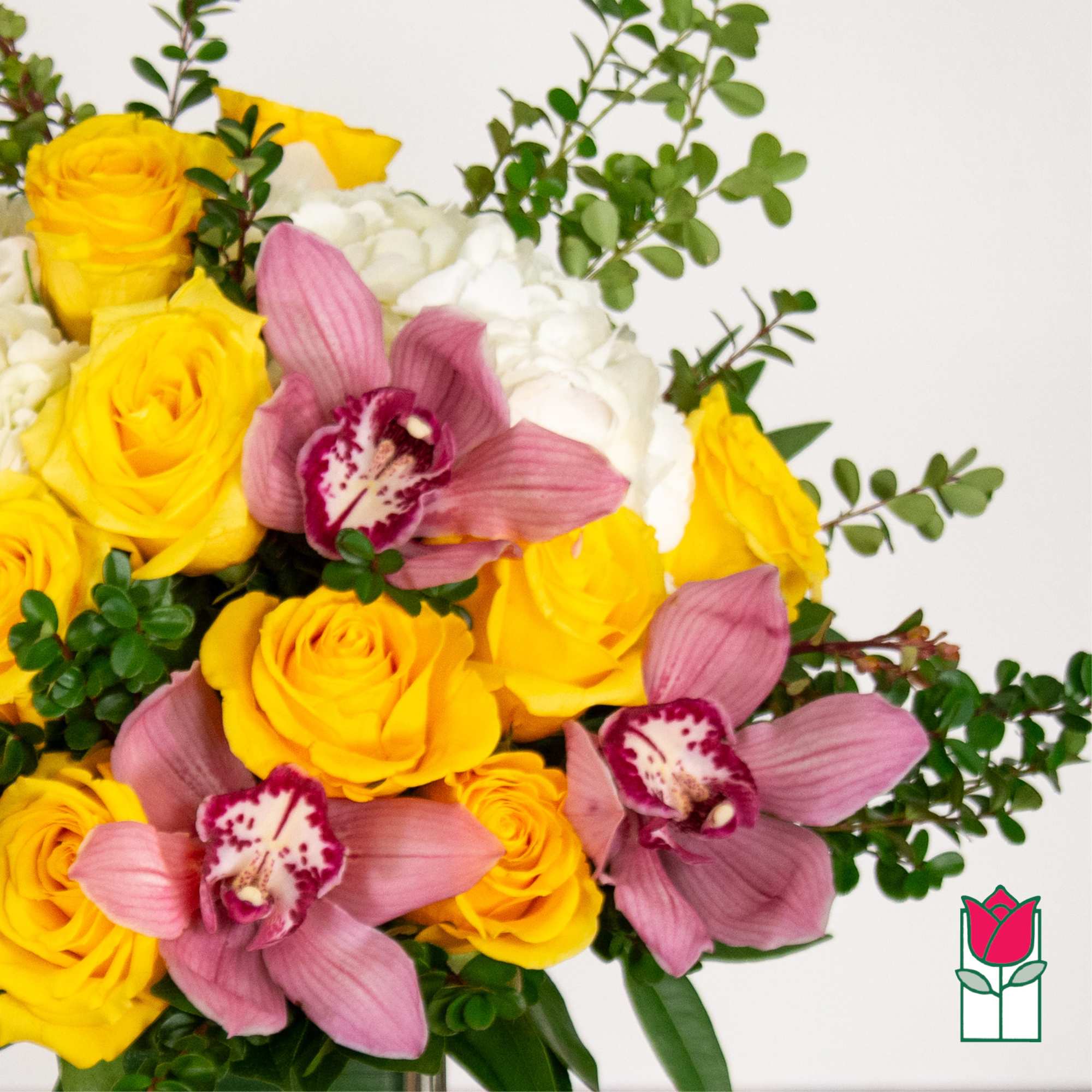 Bouquet of yellow roses, white blooms, and pink orchids