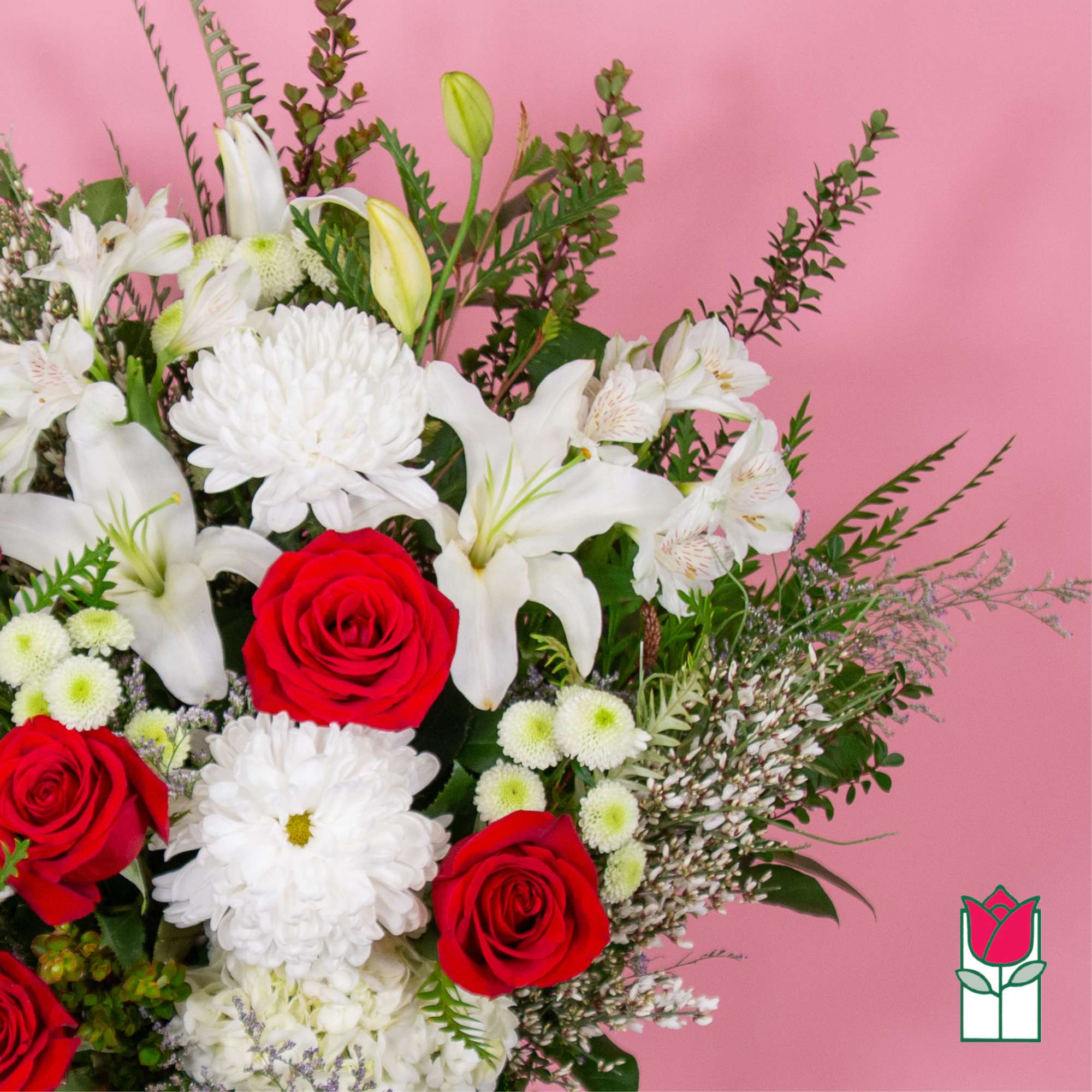 Bouquet of red roses and white lilies with white daisies on a pink background