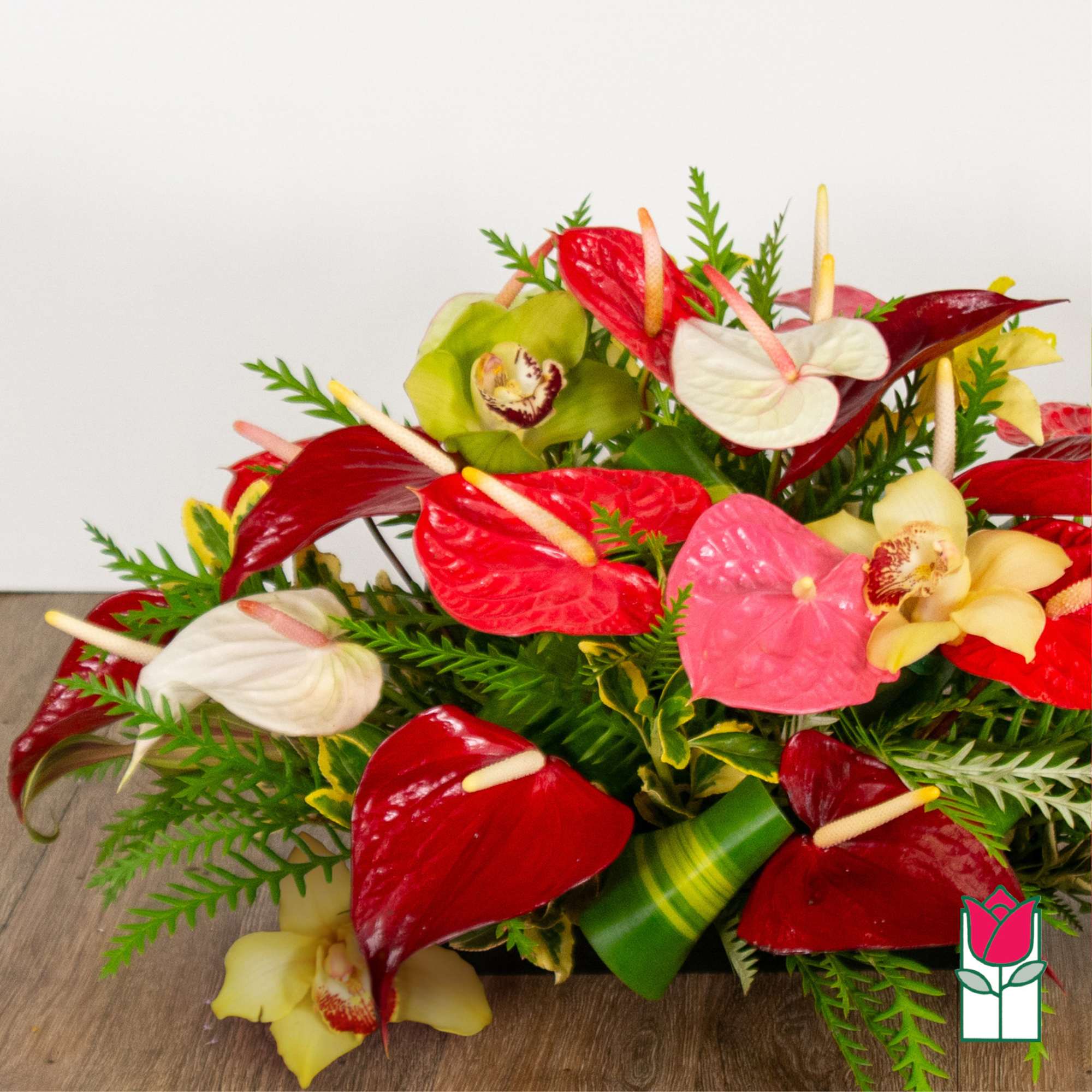 Tropical bouquet with red, pink, white, and yellow anthuriums and orchids