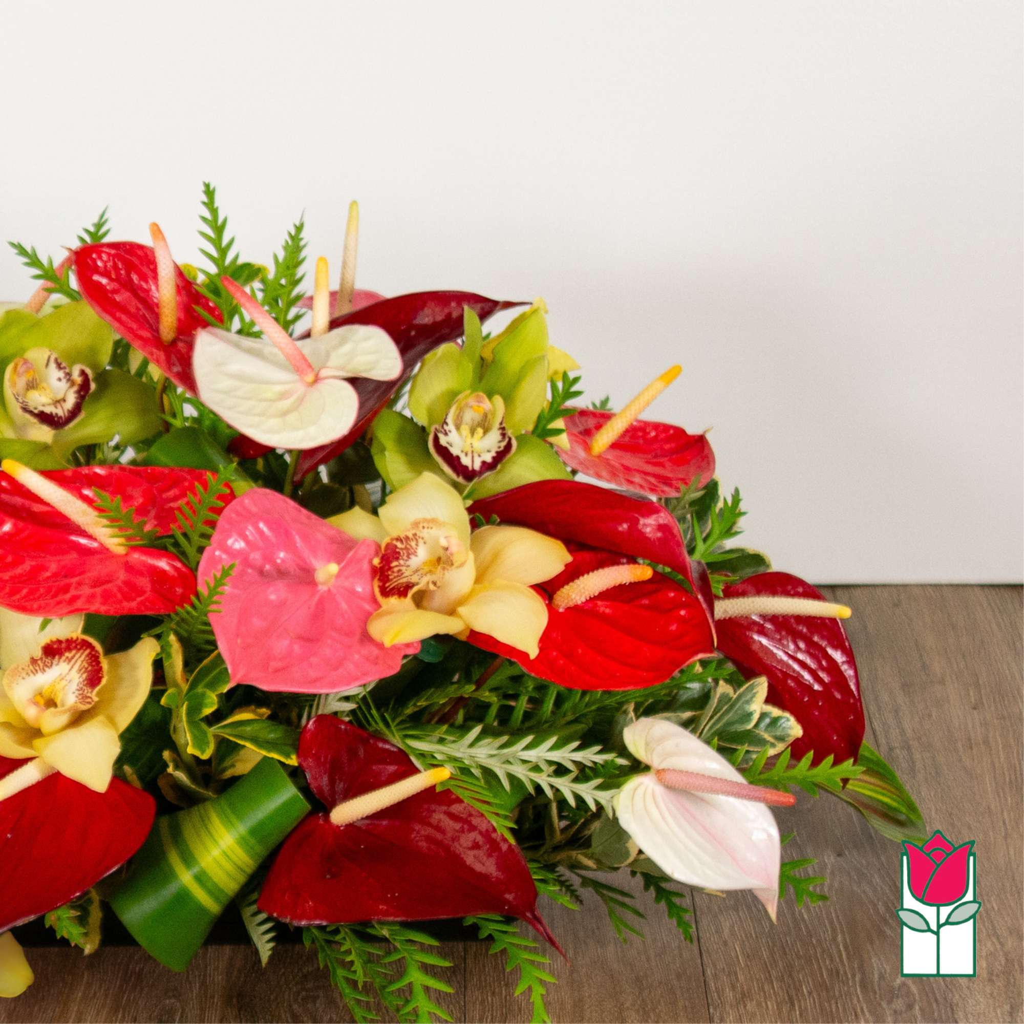 Tropical bouquet with red and white anthuriums and green orchids