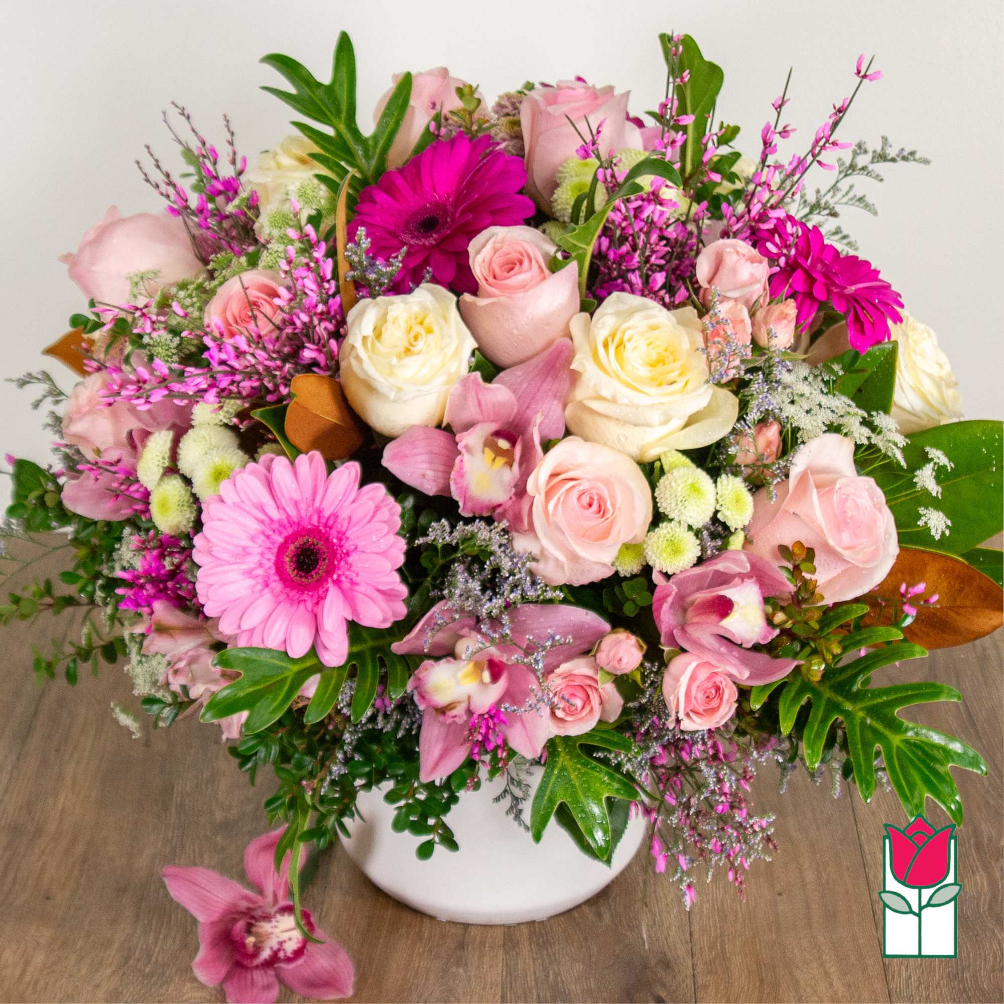 Pink and cream mixed flower arrangement in a white vase