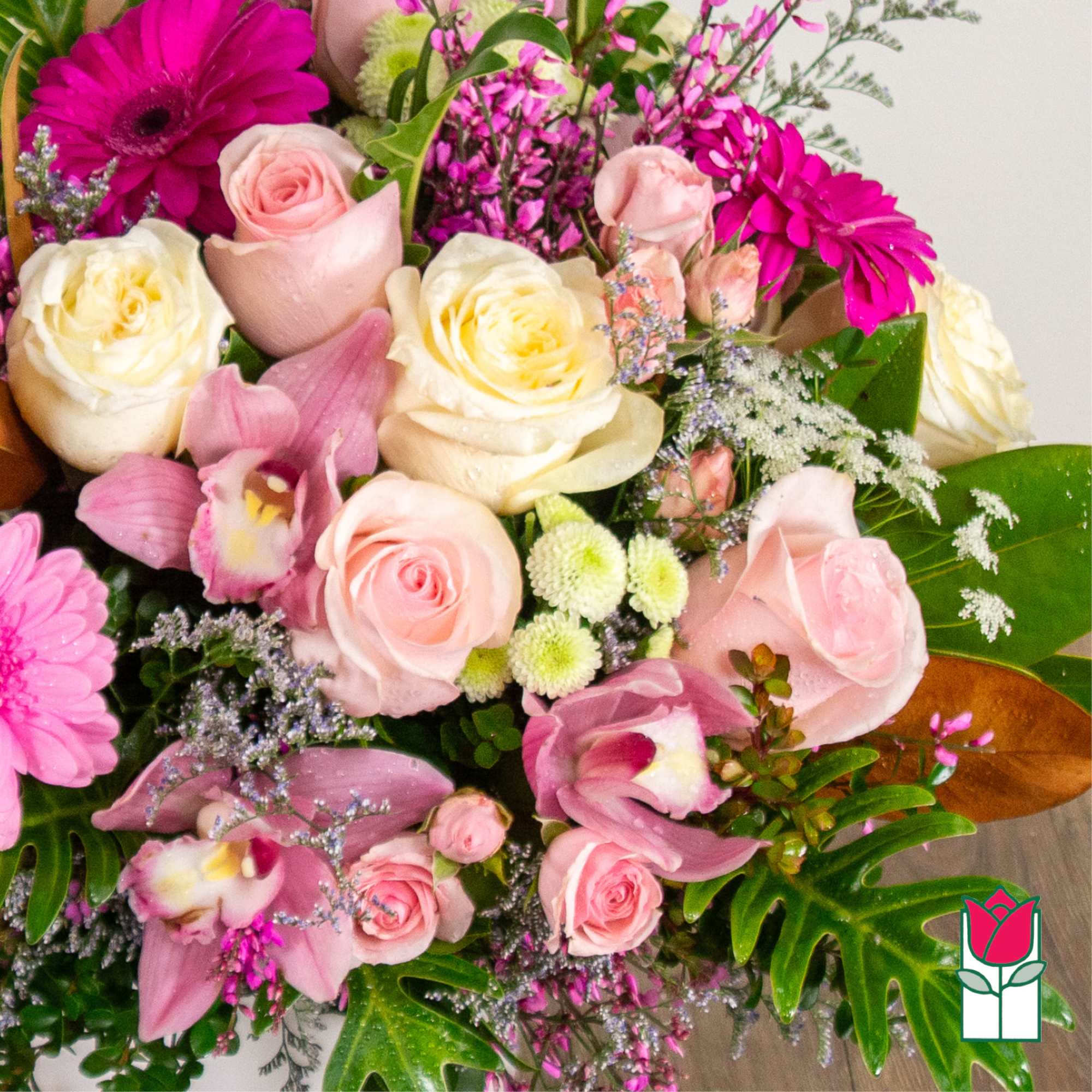 Bouquet of pink and white roses with magenta daisies and orchids