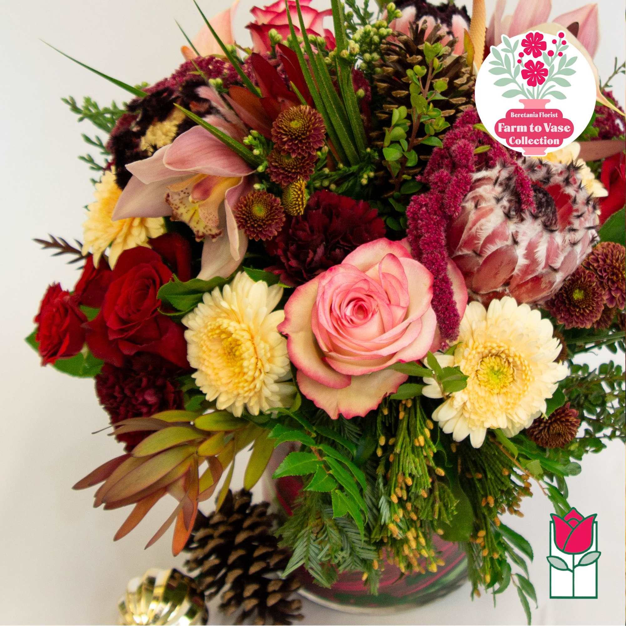 Mixed bouquet of roses, orchids, and chrysanthemums in a vase
