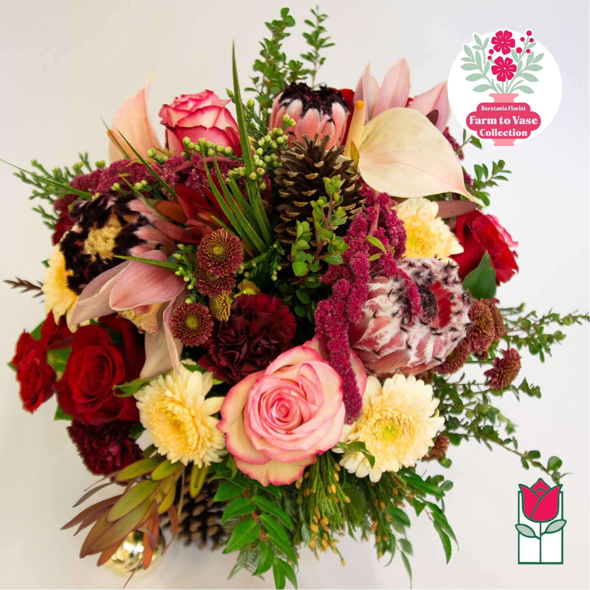 Mixed bouquet with pink roses, protea, and chrysanthemums