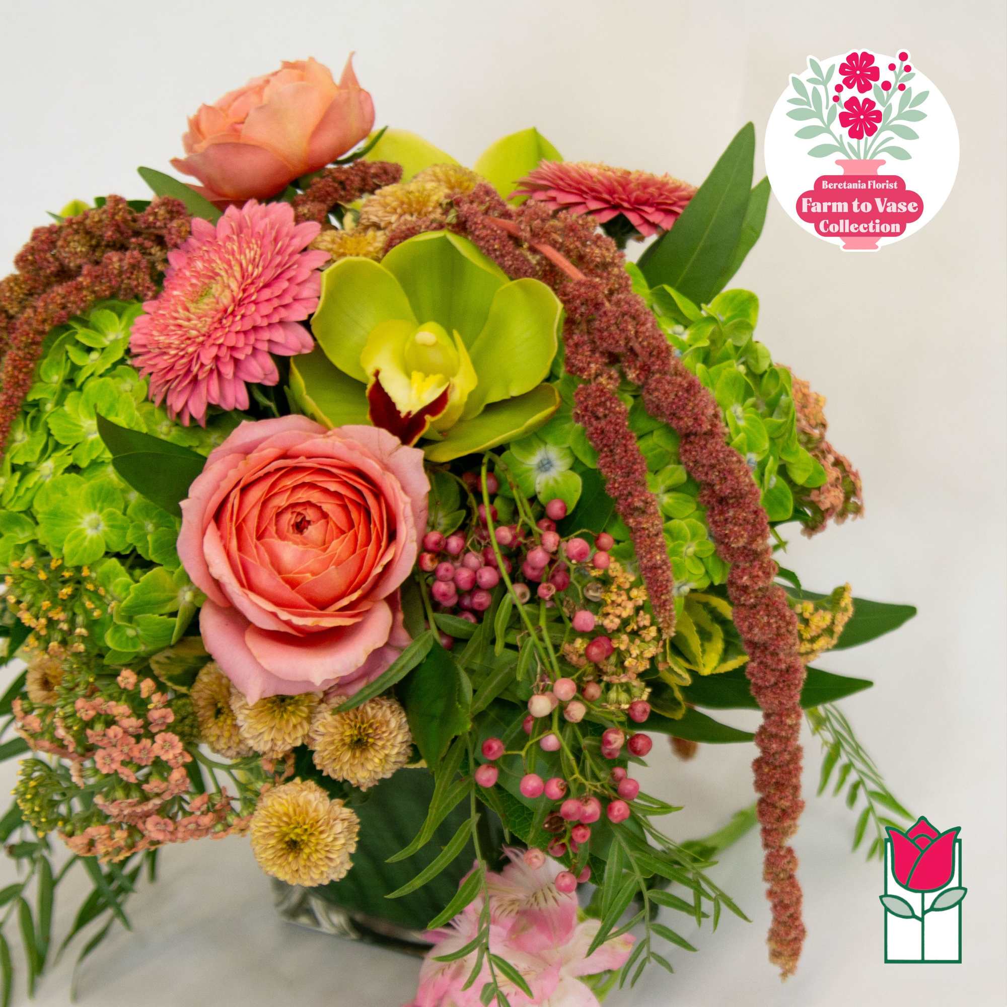 Mixed bouquet with pink roses, orchids, and green hydrangeas in a vase