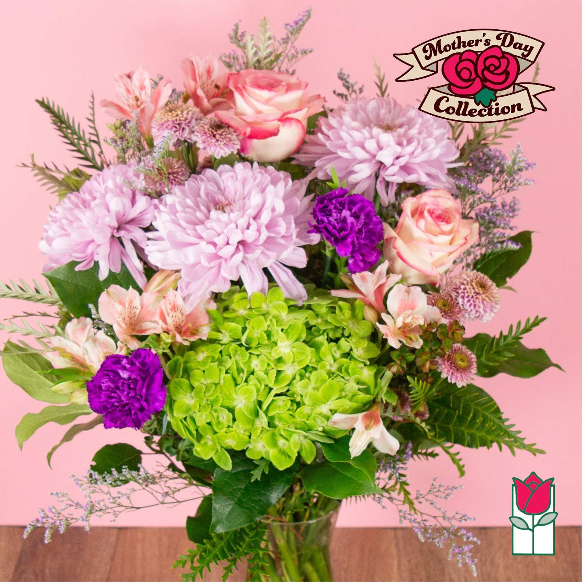 Pink and purple mixed bouquet with green hydrangea in a glass vase