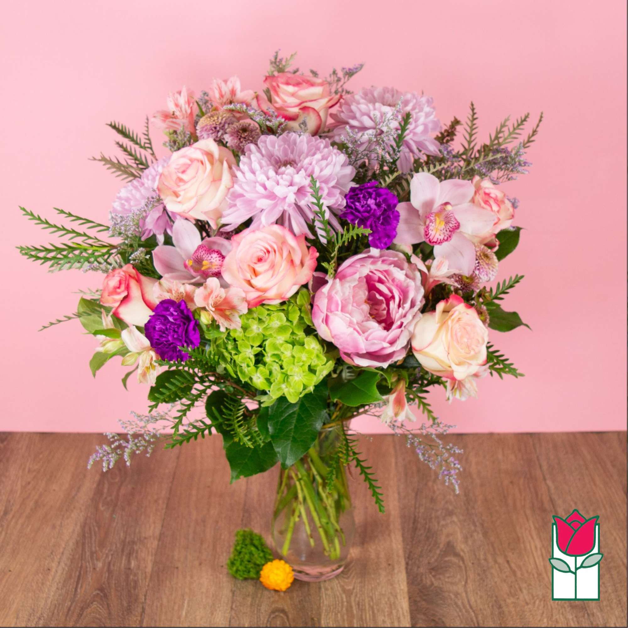 Pink and purple mixed bouquet in a clear glass vase