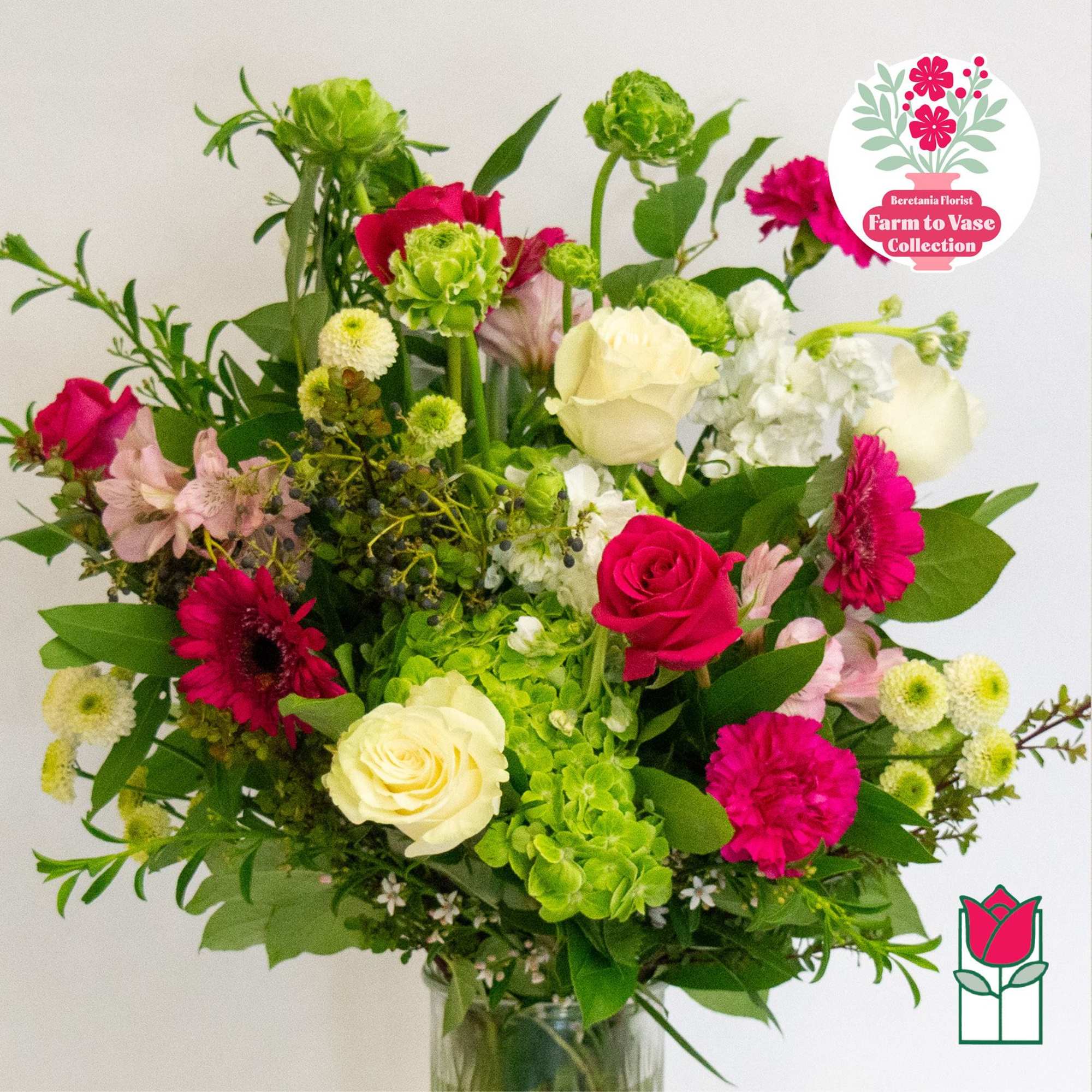 Mixed bouquet of pink and white flowers in a glass vase