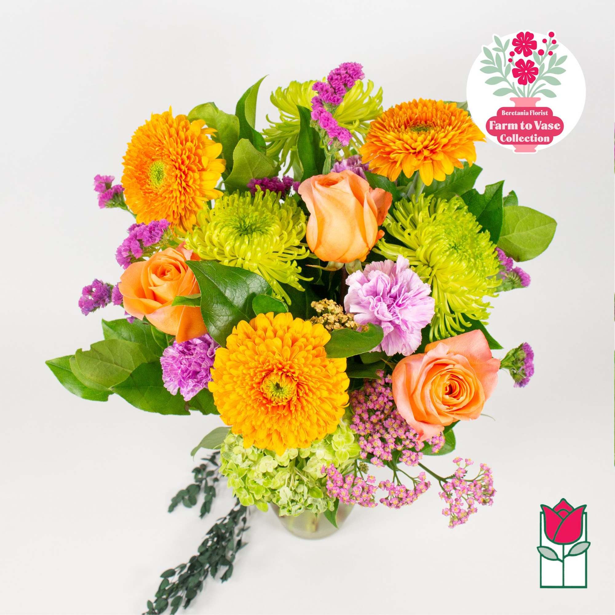Bouquet of orange roses and yellow chrysanthemums in a glass vase