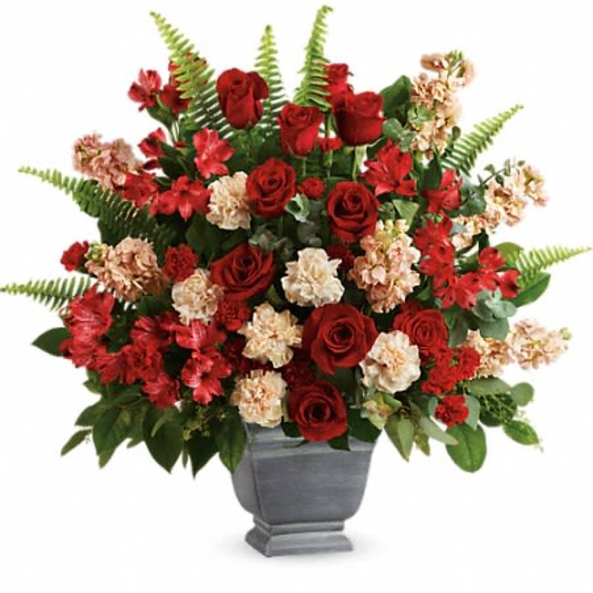 Large red and cream flower arrangement with roses and carnations in a gray urn-style vase
