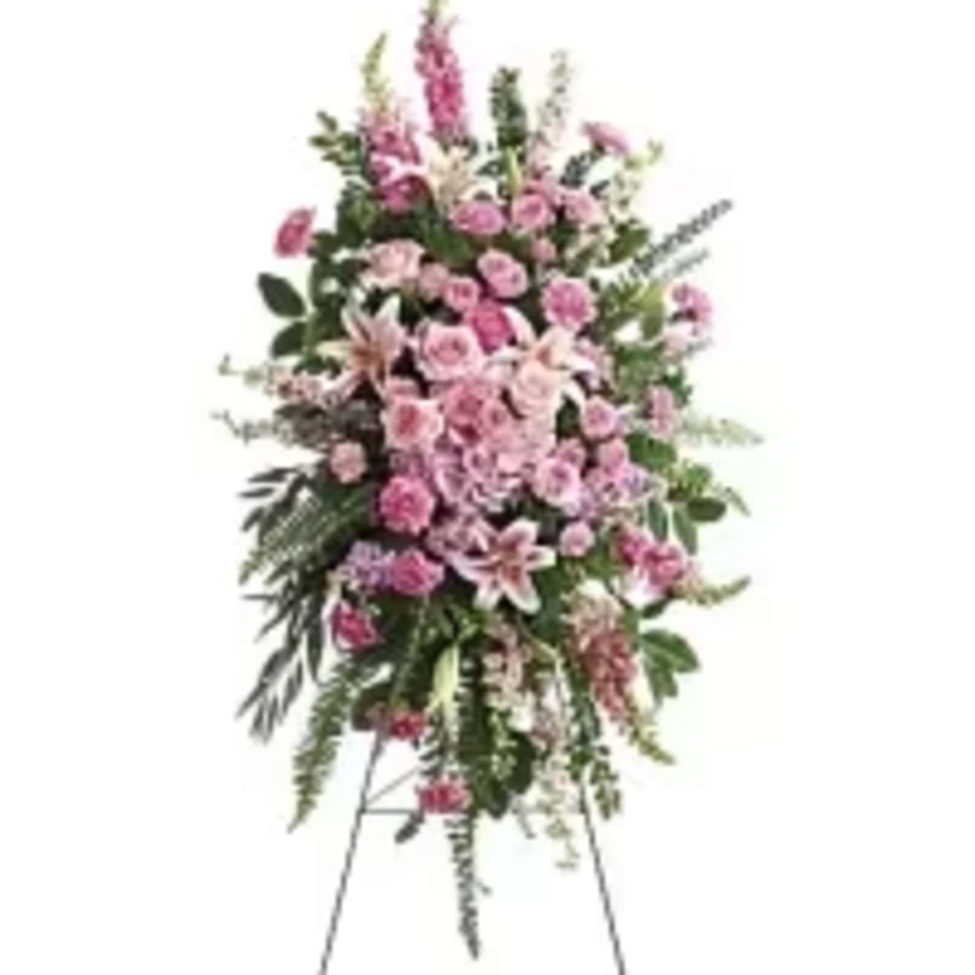 Tall pink standing spray of lilies, roses, and carnations on a metal easel