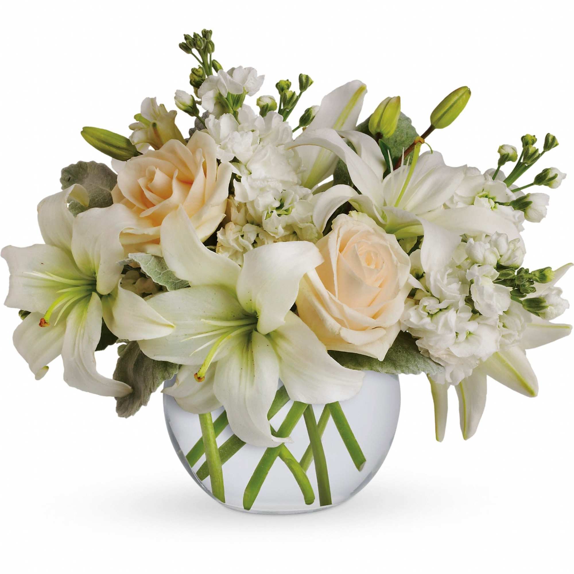 Low arrangement of white lilies and cream roses in a round glass vase