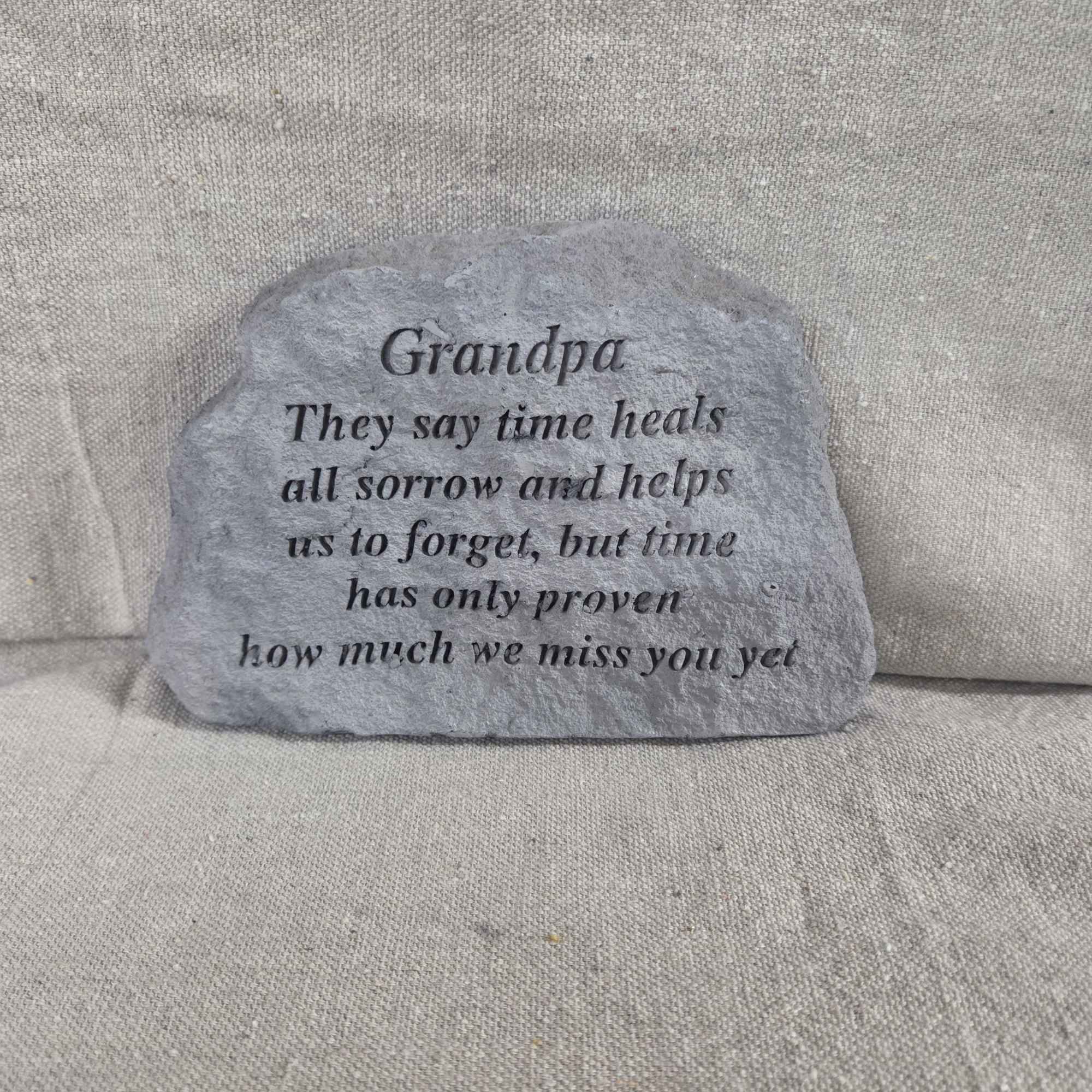 Gray memorial stone engraved with a sentimental message for a grandpa.