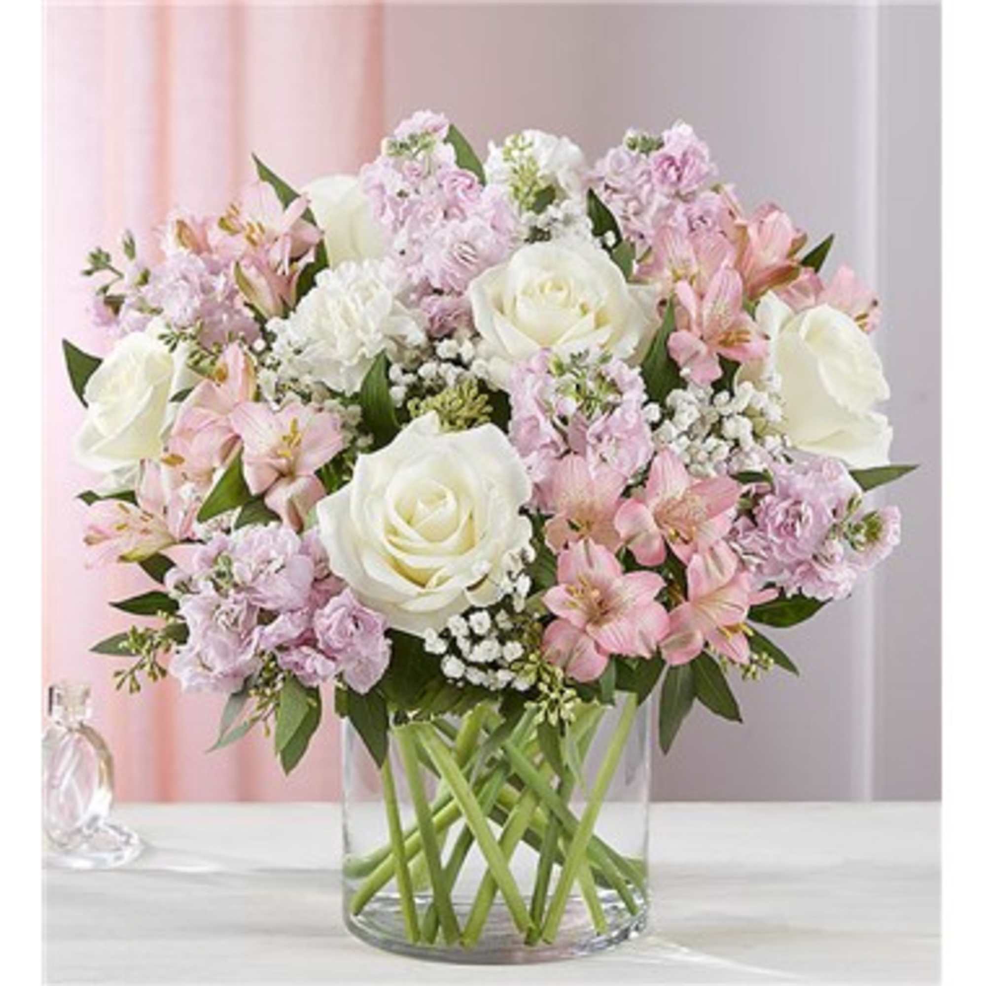 Pink and white mixed flower bouquet in a clear glass vase