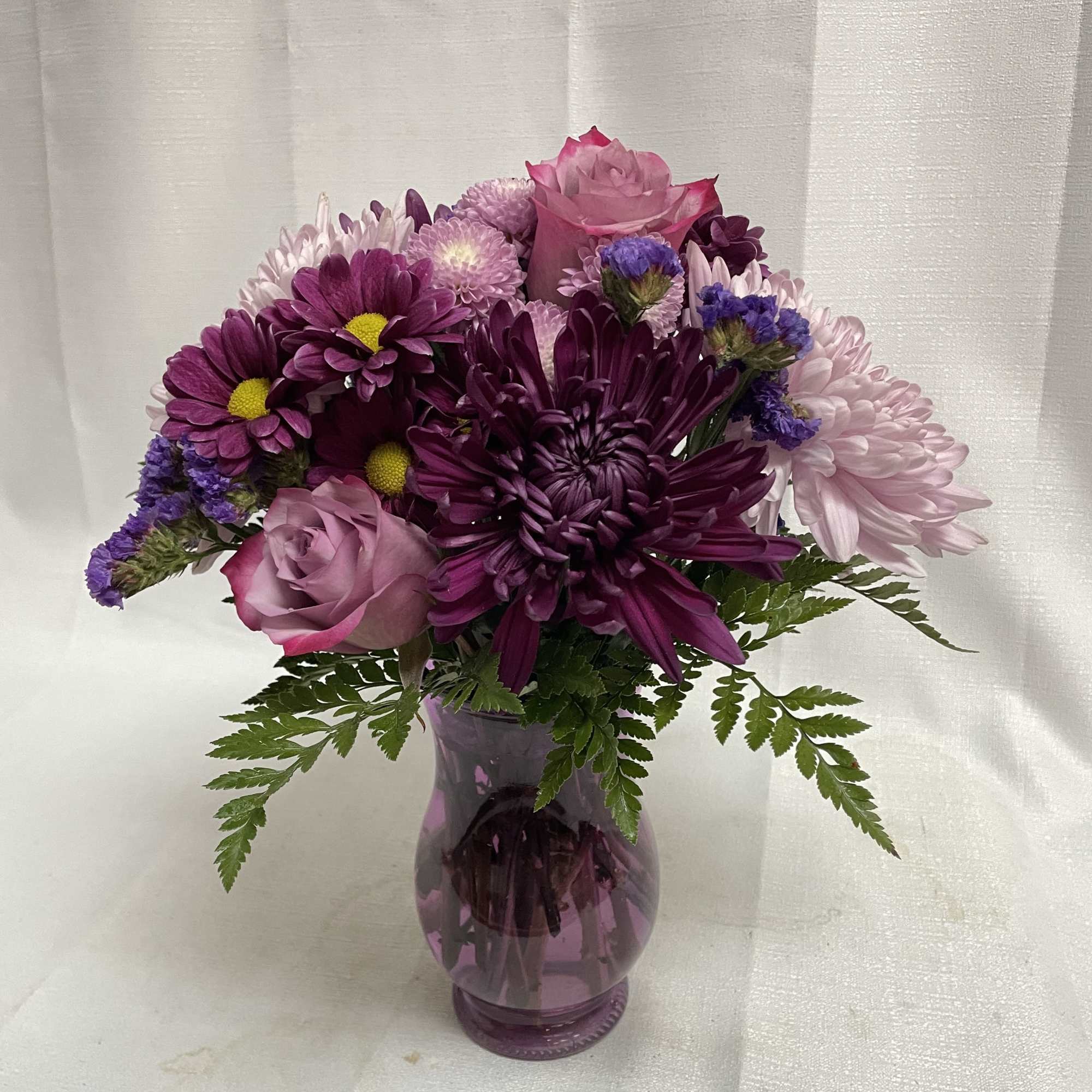 A beautiful arrangement of fabulous purples, certain to put a smile on