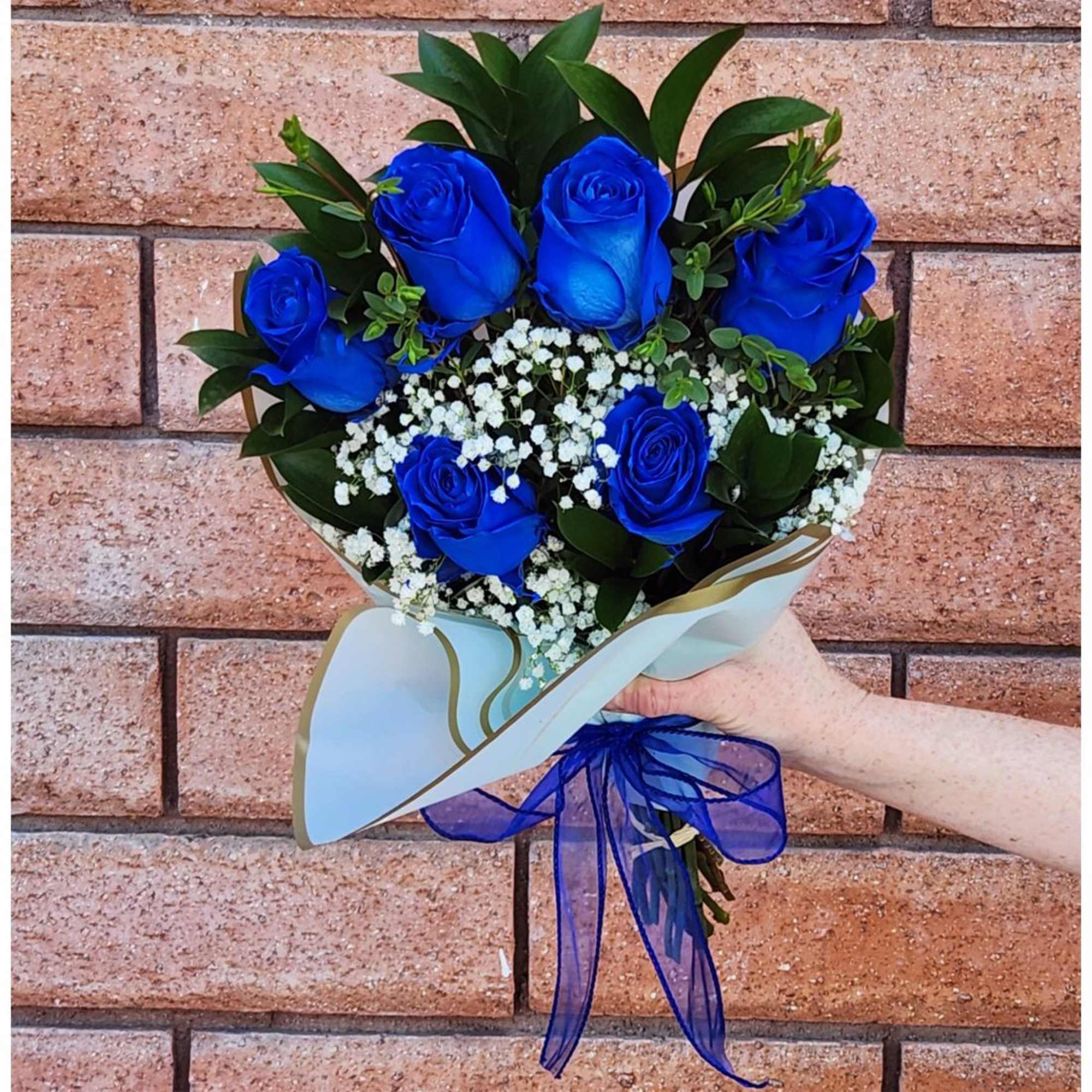 Bouquet of blue roses with white baby's breath and a blue ribbon