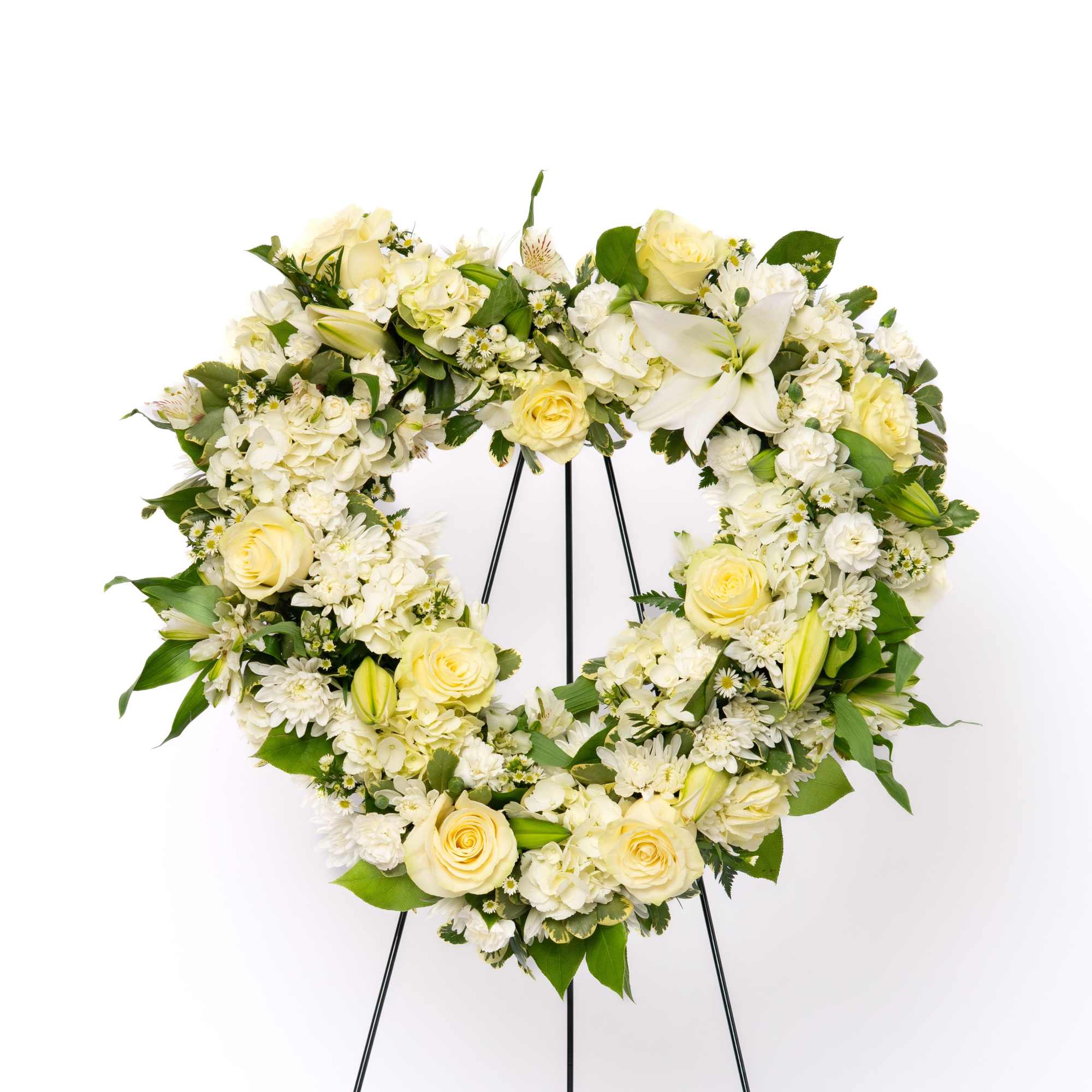 A timeless symbol of love and remembrance, this heart-shaped wreath offers a