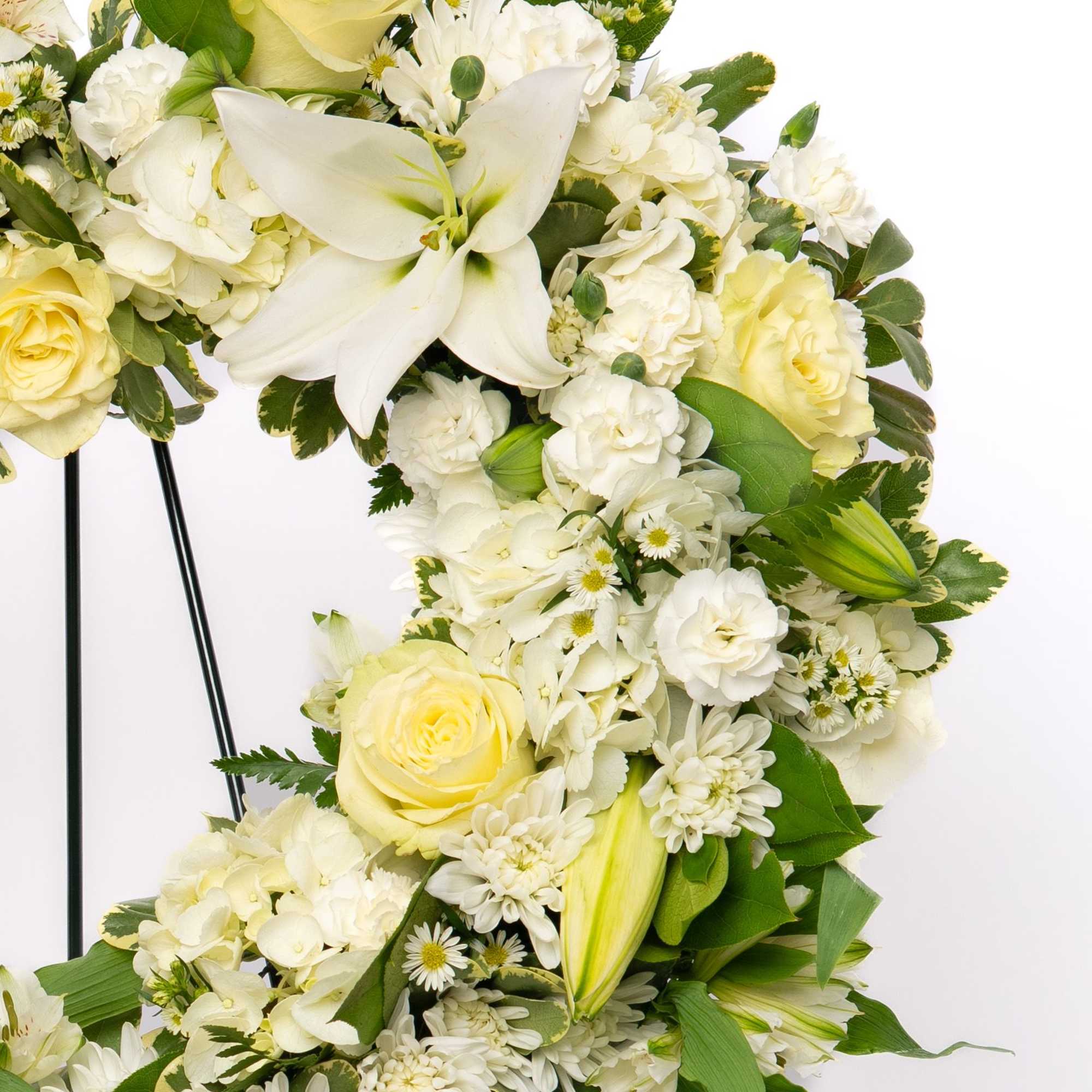 A timeless symbol of love and remembrance, this heart-shaped wreath offers a