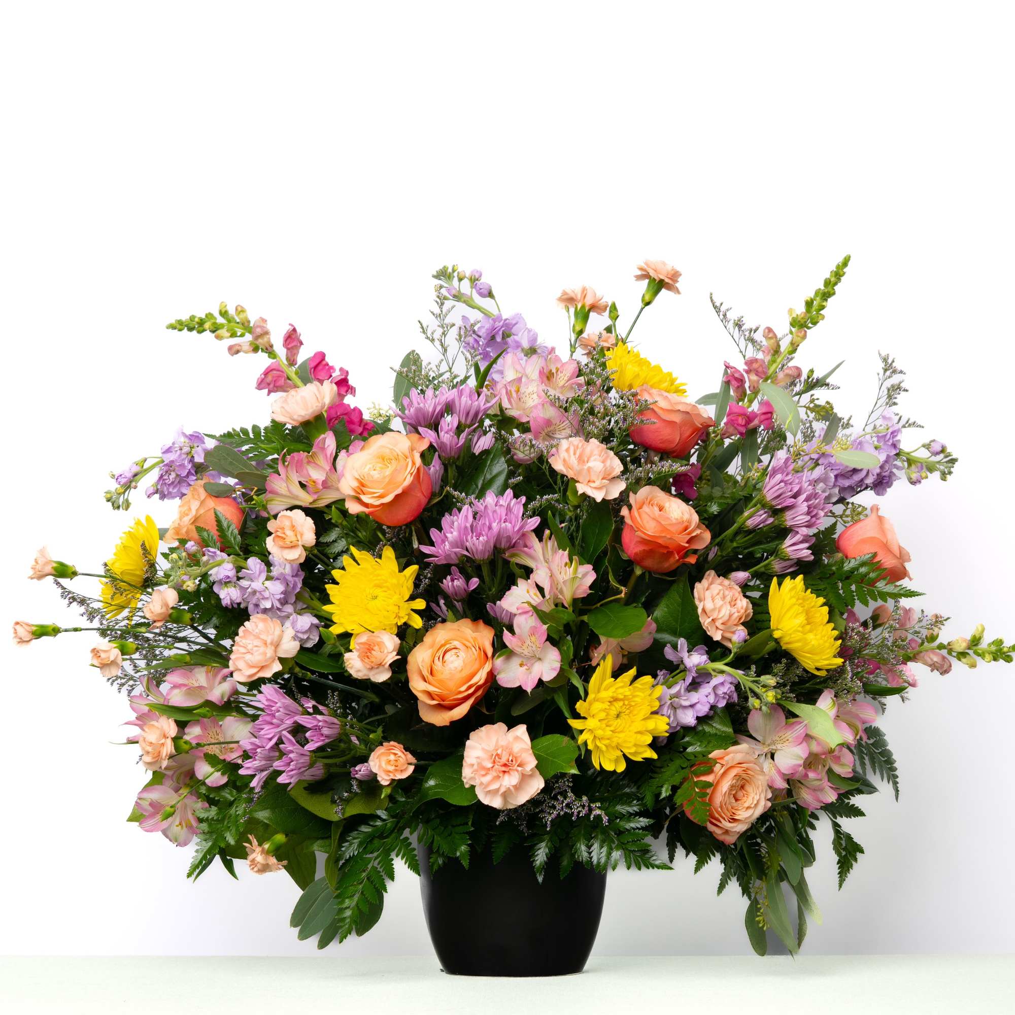Soft pastel blooms create a gentle and comforting tribute, offering a sense