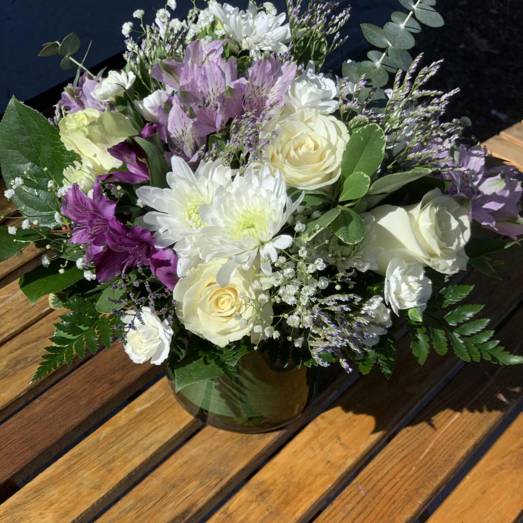Bouquet of white and lavender flowers in a glass vase