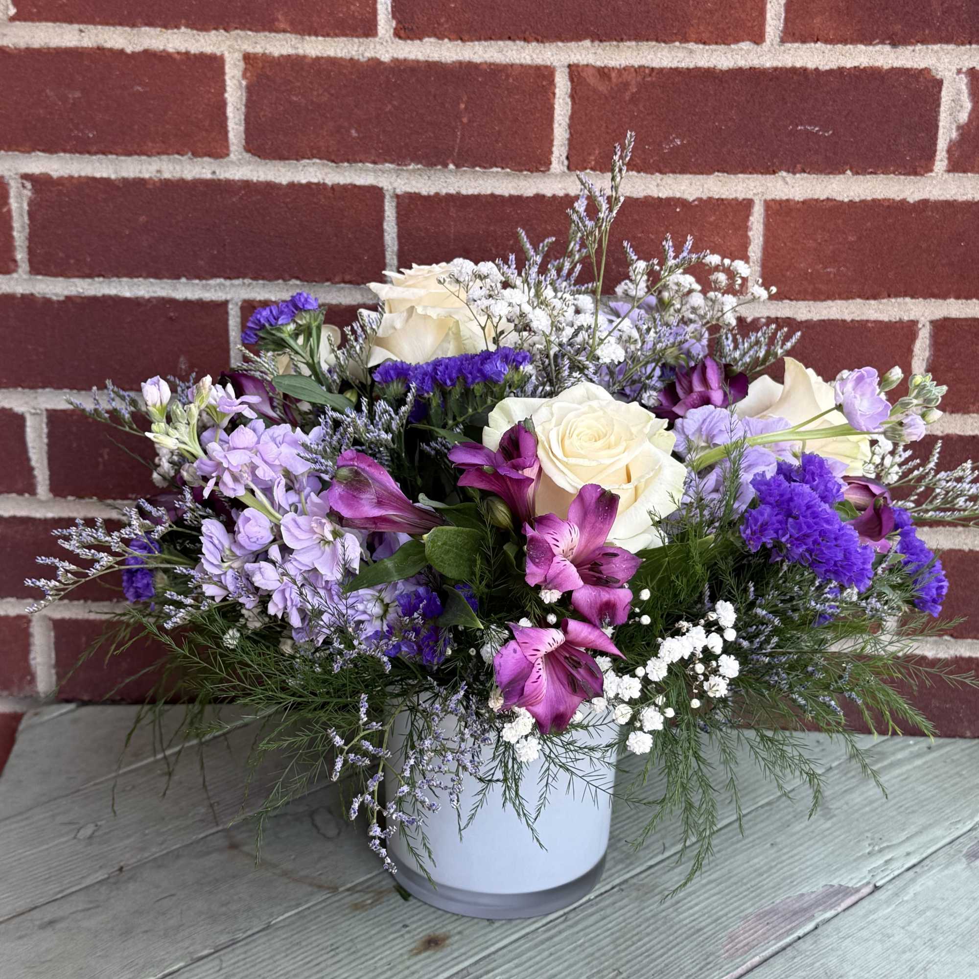 Charming lavender flower bouquet is loosely gathered with a medley of lavender