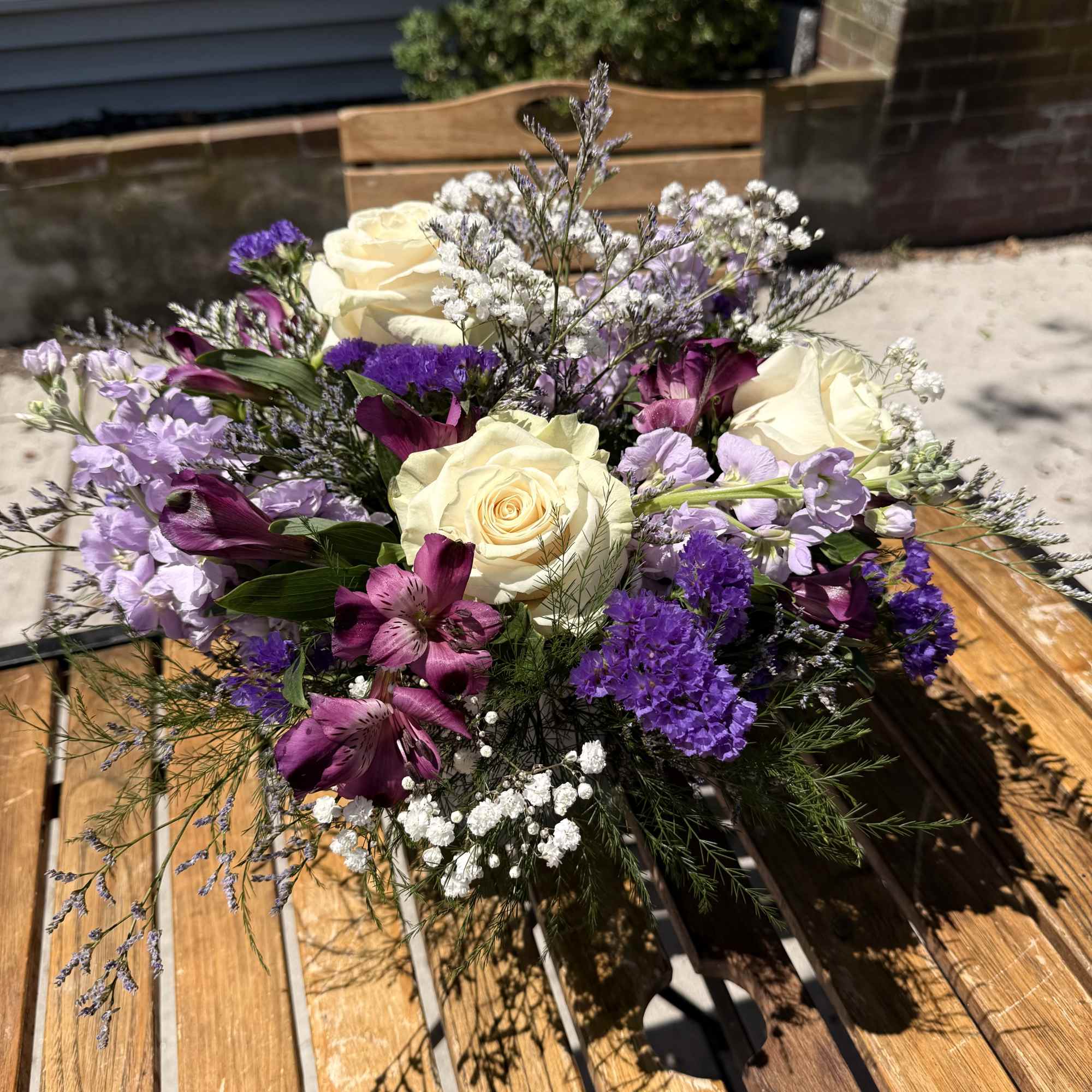 Charming lavender flower bouquet is loosely gathered with a medley of lavender