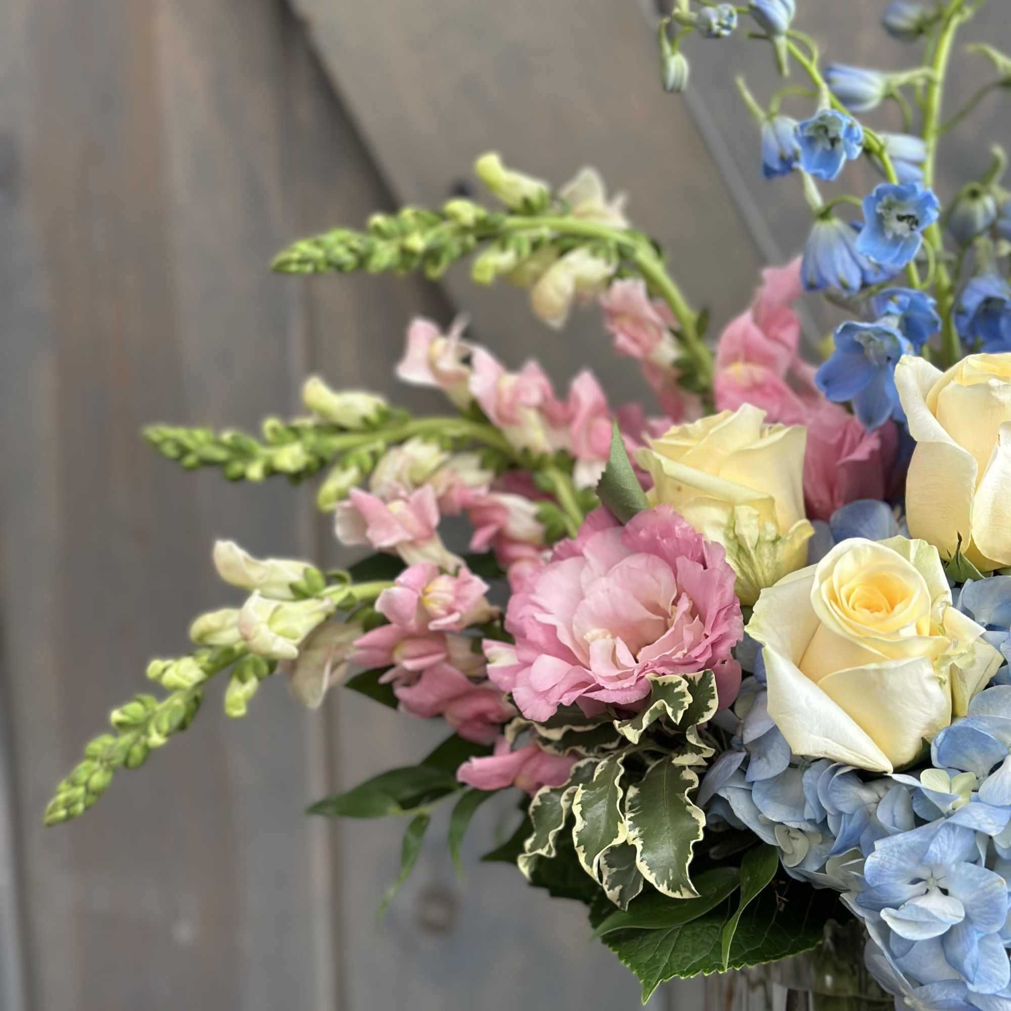 This fun and spring inspired arrangement includes Roses, hydrangea, Mini hydrangea, Sweet