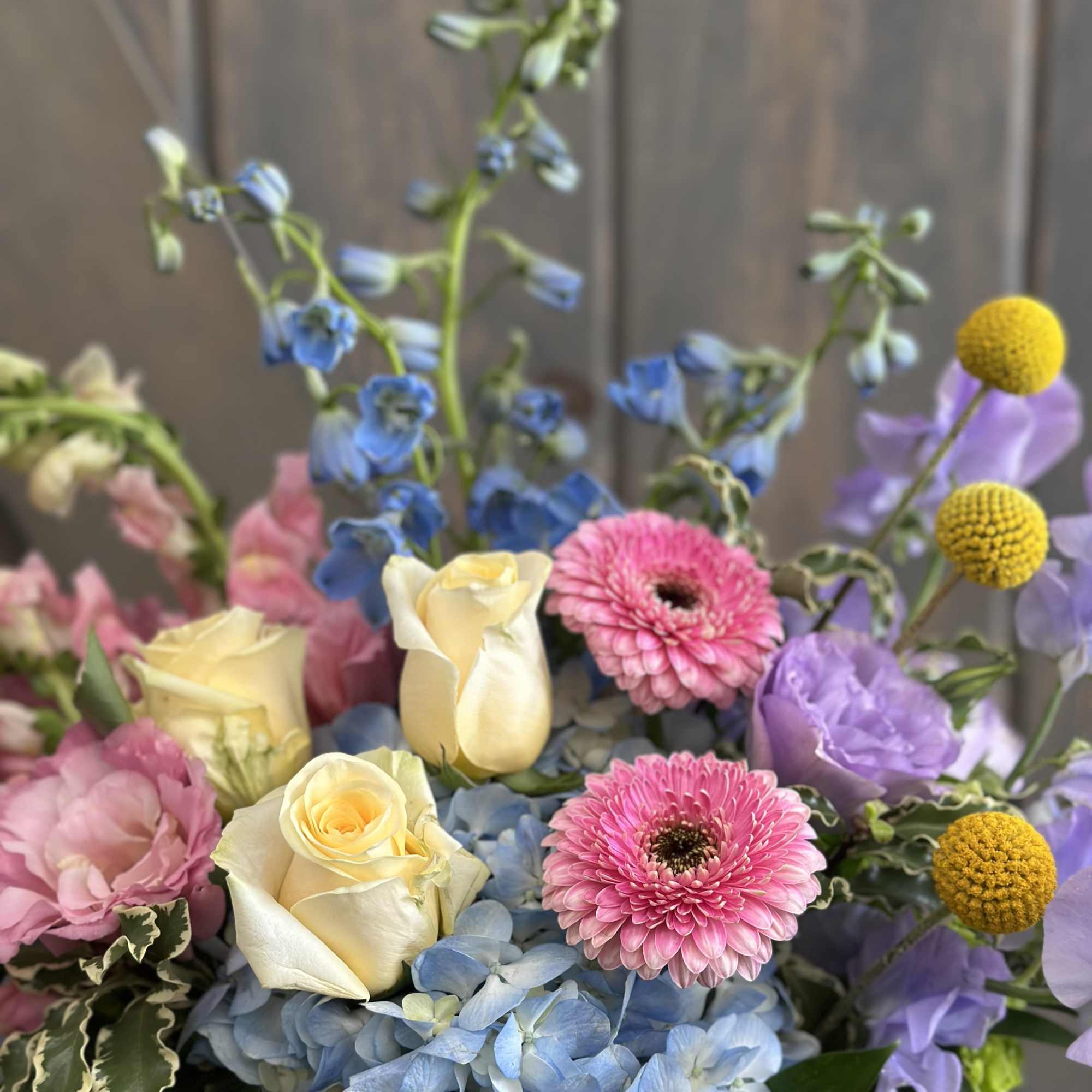 This fun and spring inspired arrangement includes Roses, hydrangea, Mini hydrangea, Sweet