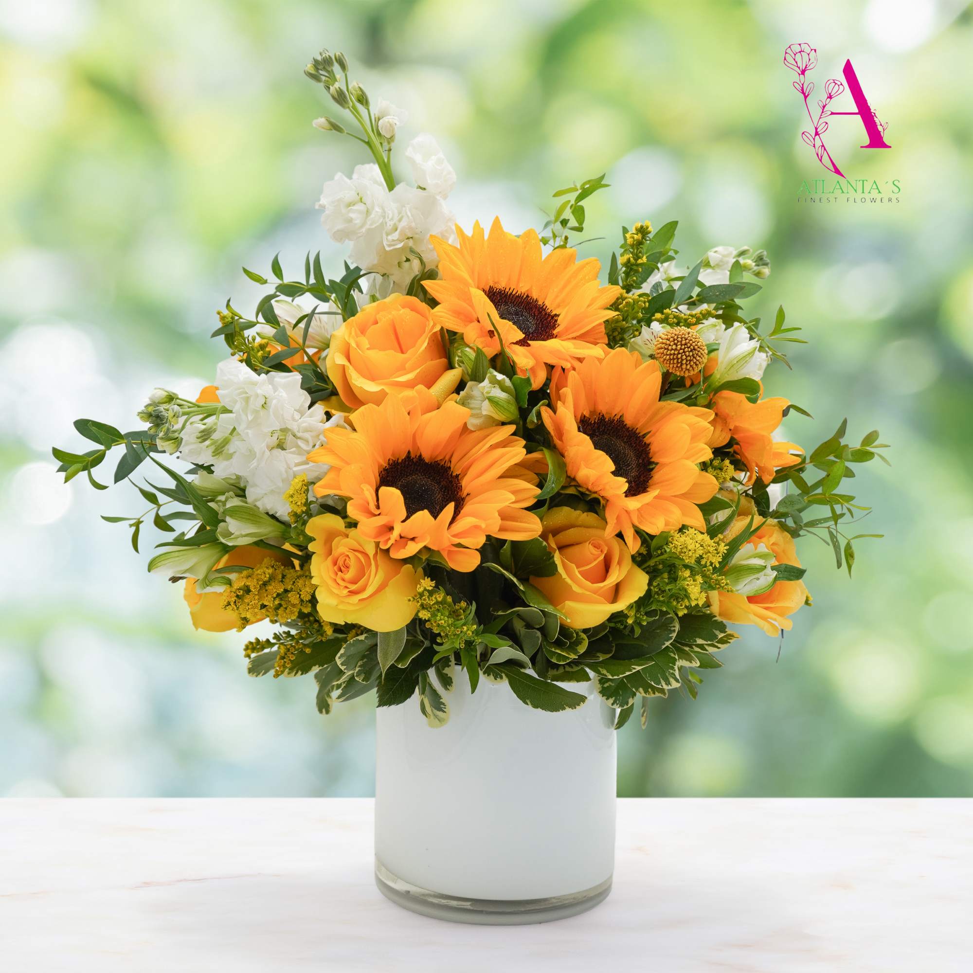 Orange sunflowers and roses in a white vase