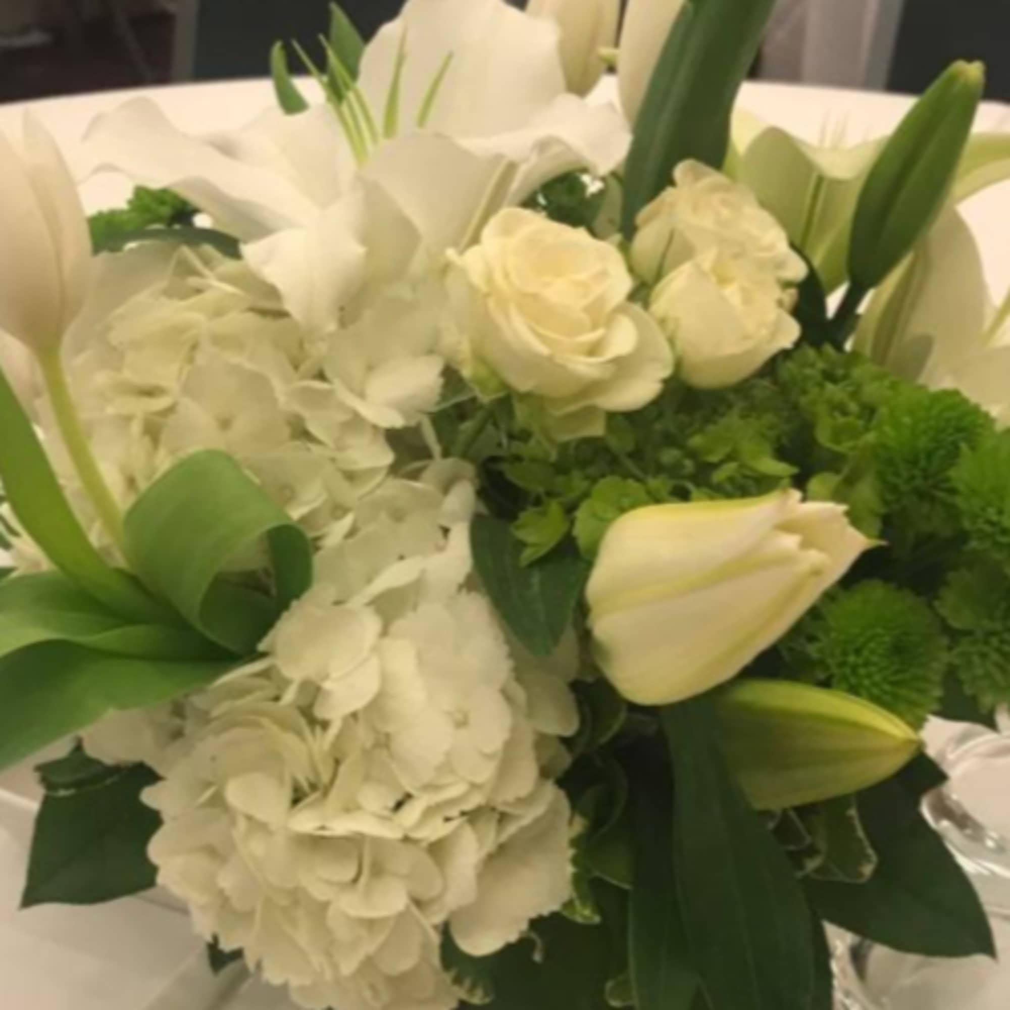White floral bouquet with tulips, roses, and hydrangeas