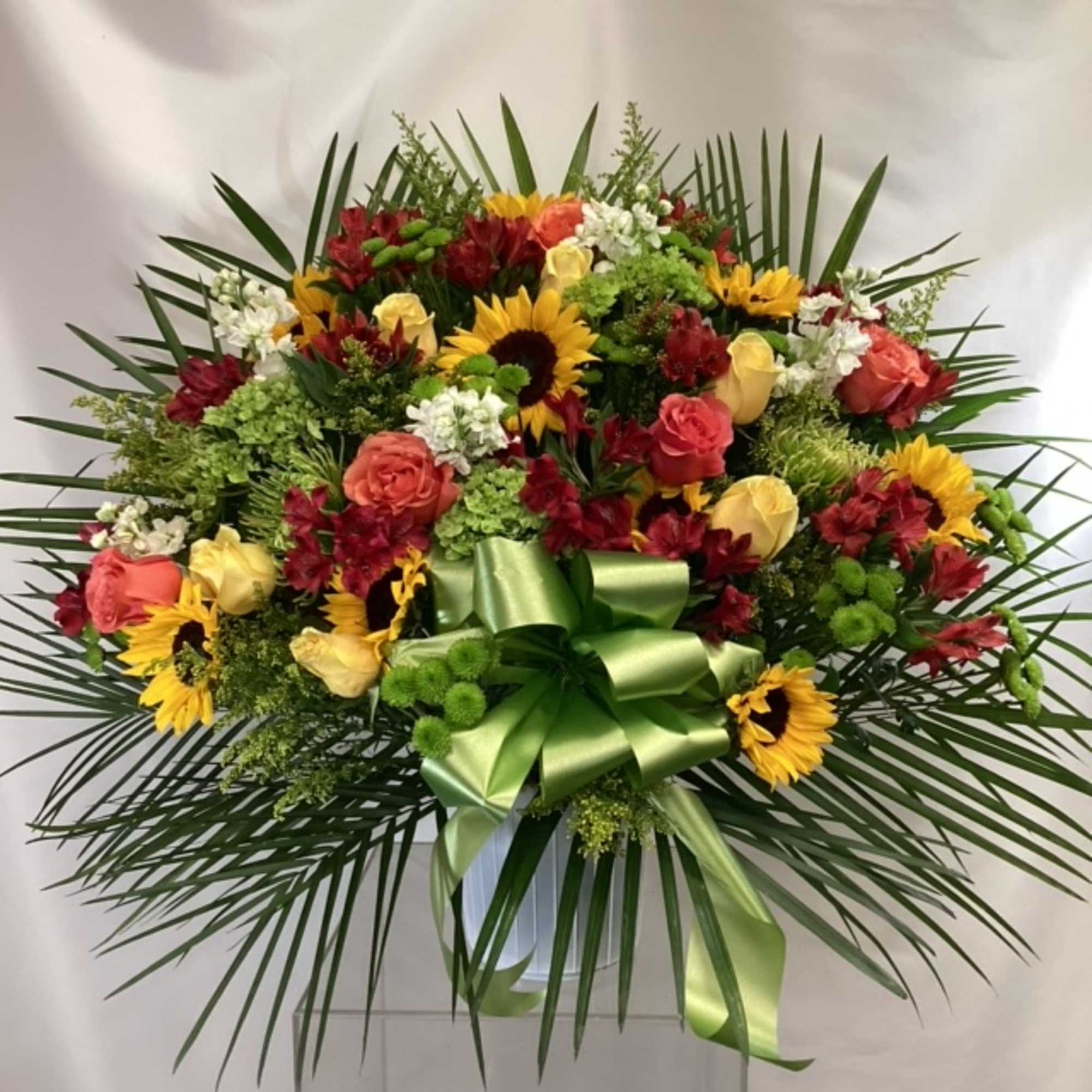 Large mixed bouquet with sunflowers, roses, and alstroemeria in a vase