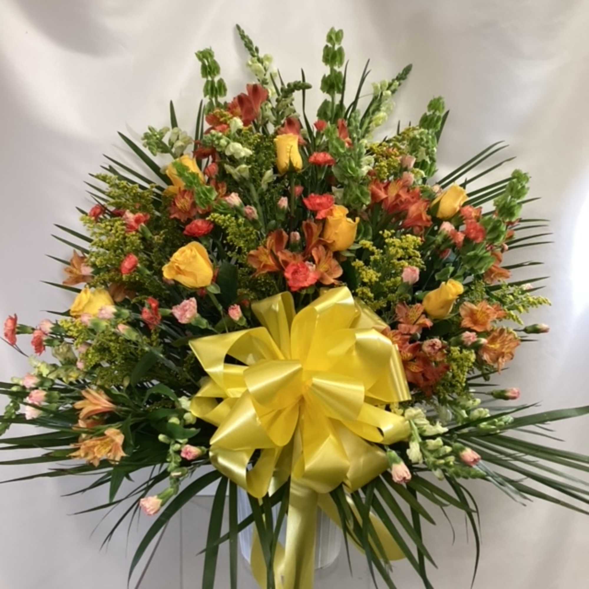 Large mixed floral spray with yellow ribbon bow