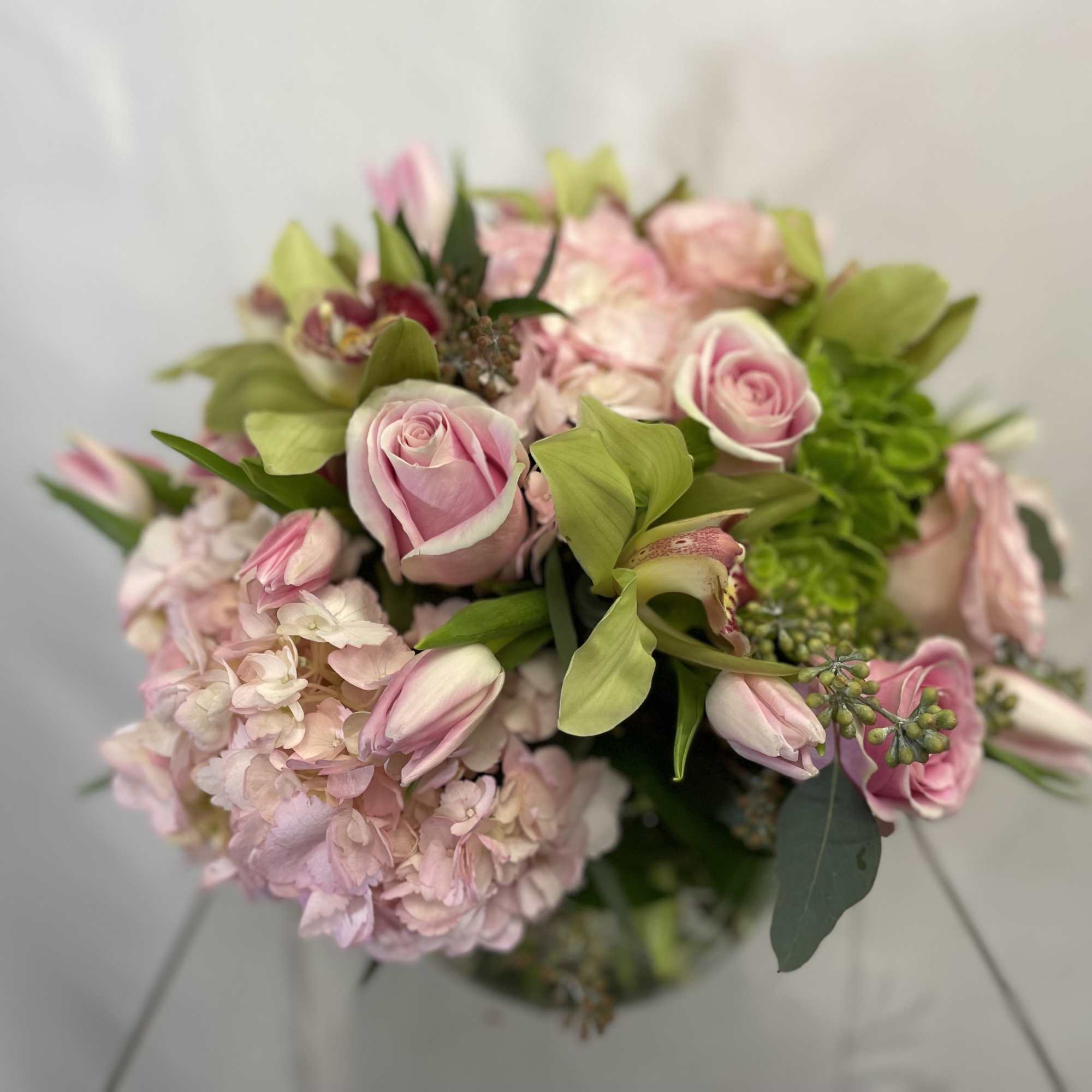 Pink roses and tulips with pale hydrangea in a bouquet