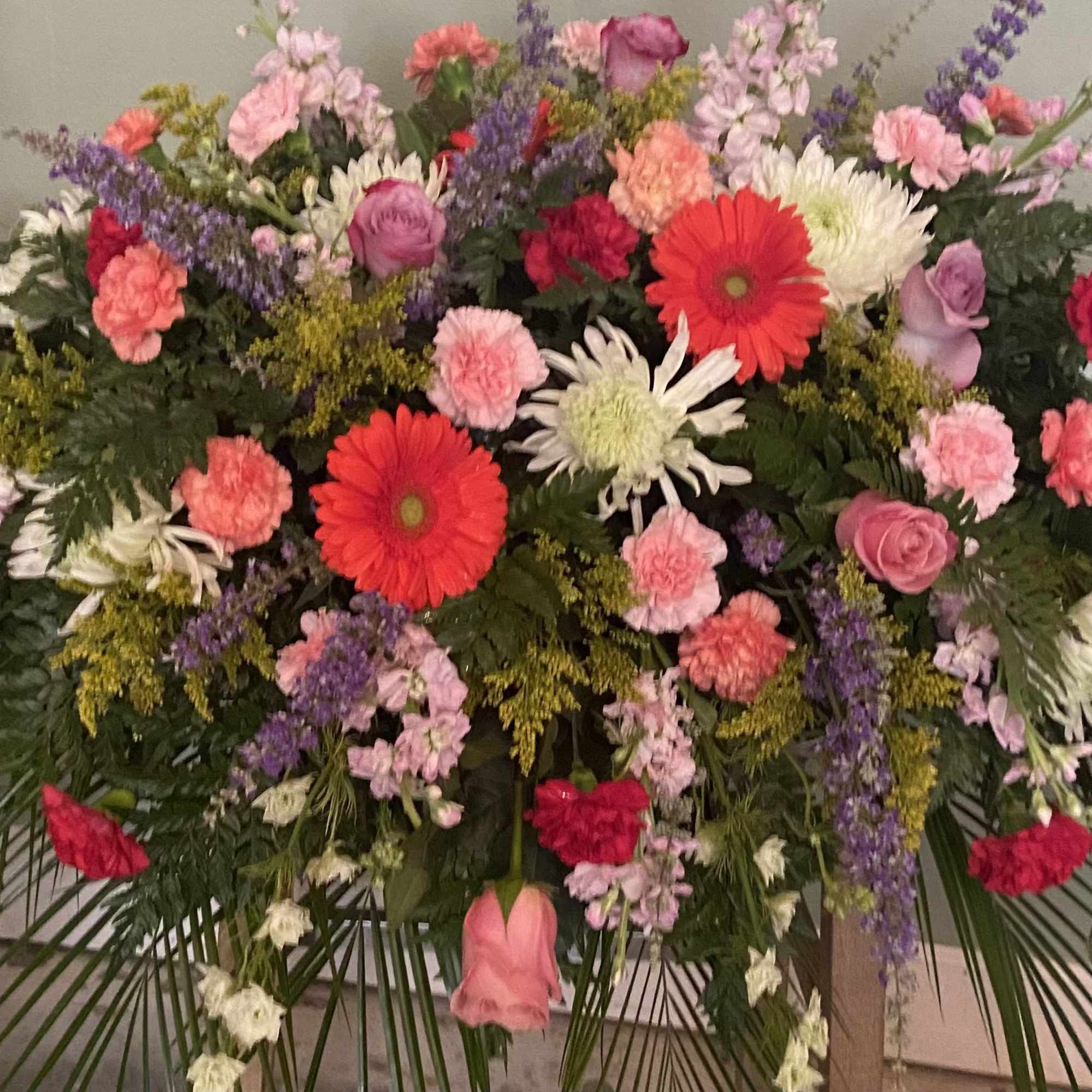 Large mixed floral spray with pink, red, and white blooms