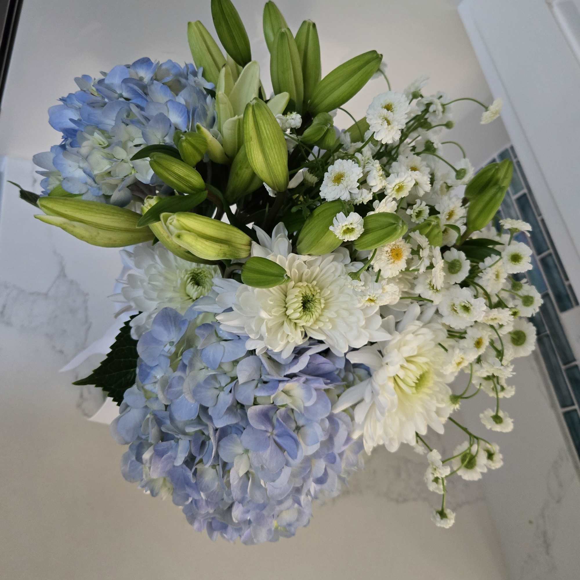 Contains 20 stems of white and blue blooms. 
Displayed in a clear, photo 2 of 2