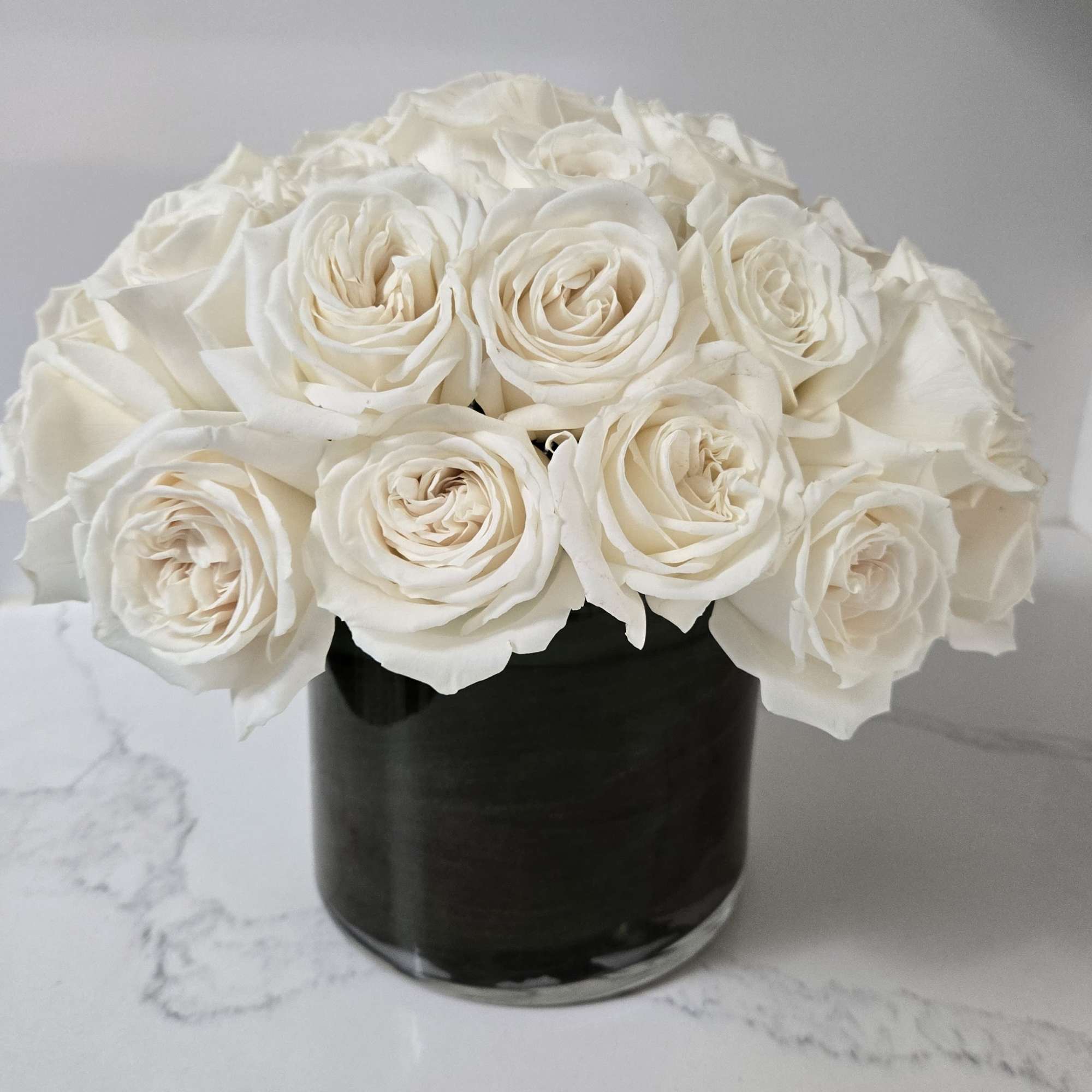 Simple yet elegant. Contains 36 stems of white roses. 
Displayed in a