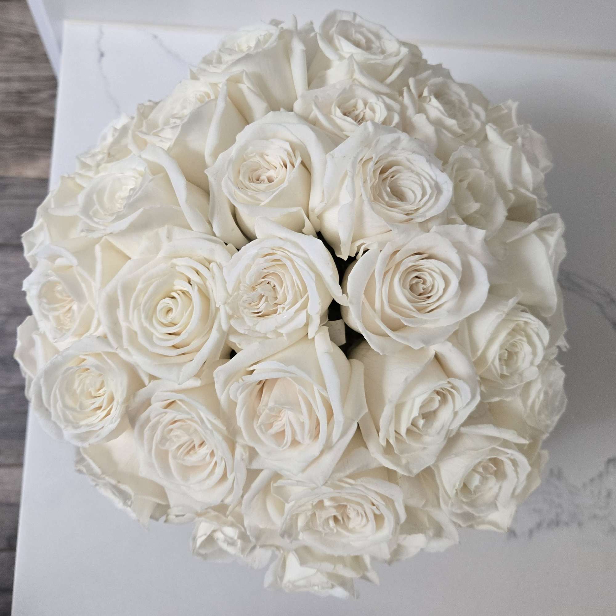 Simple yet elegant. Contains 36 stems of white roses. 
Displayed in a, photo 2 of 2