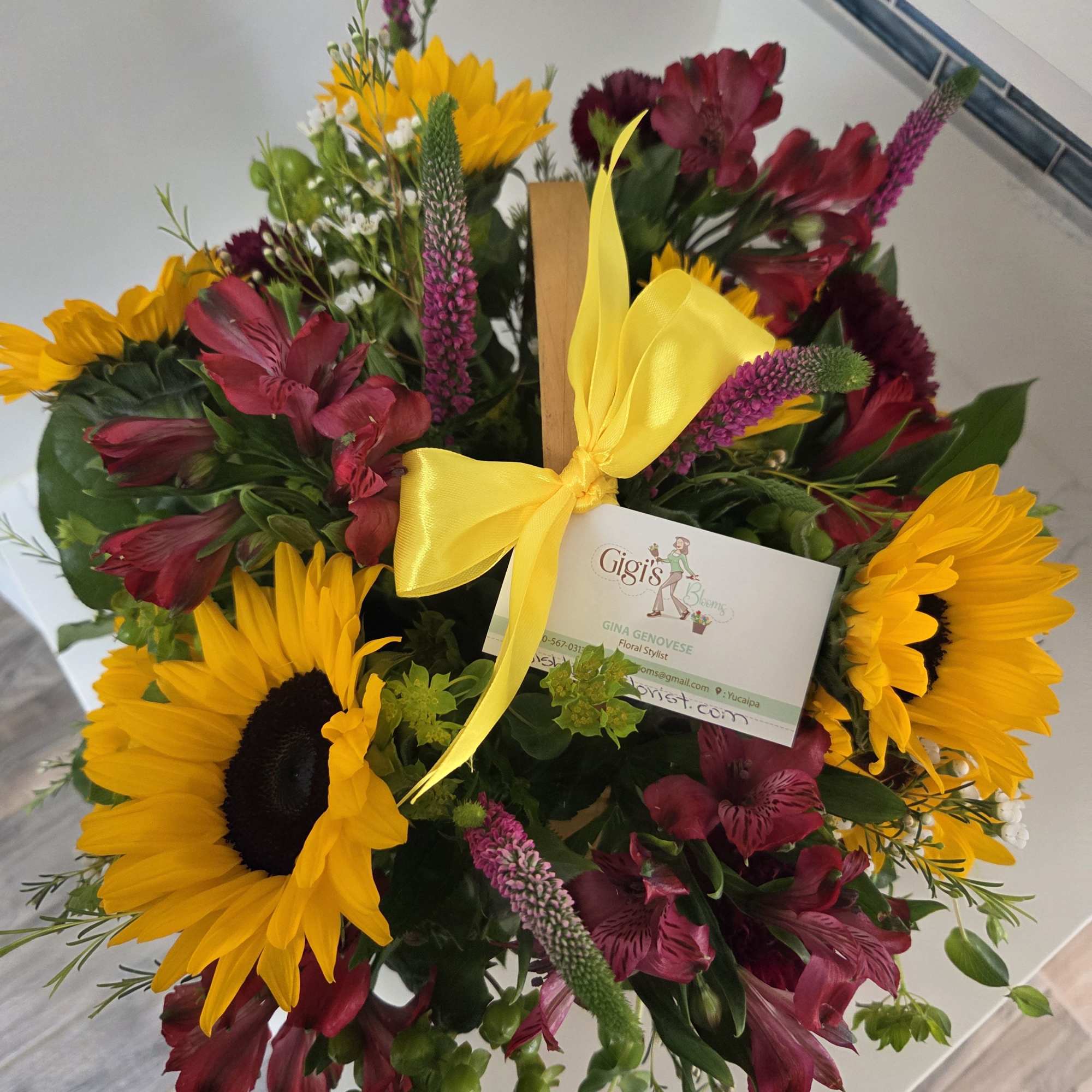 A basket filled with fall sunflowers and flowers in shades of yellow, photo 2 of 3