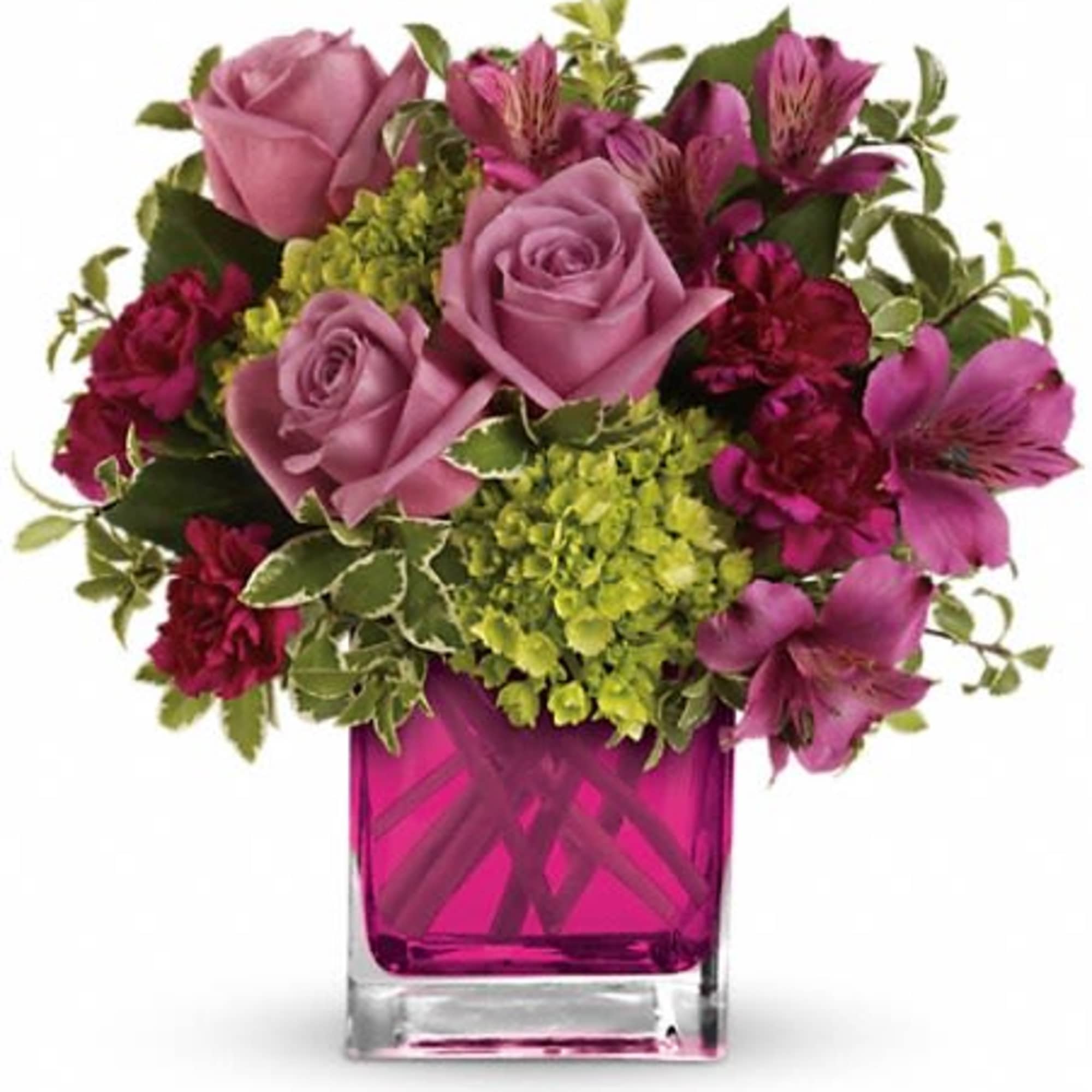 Pink and magenta flowers arranged in a square glass vase