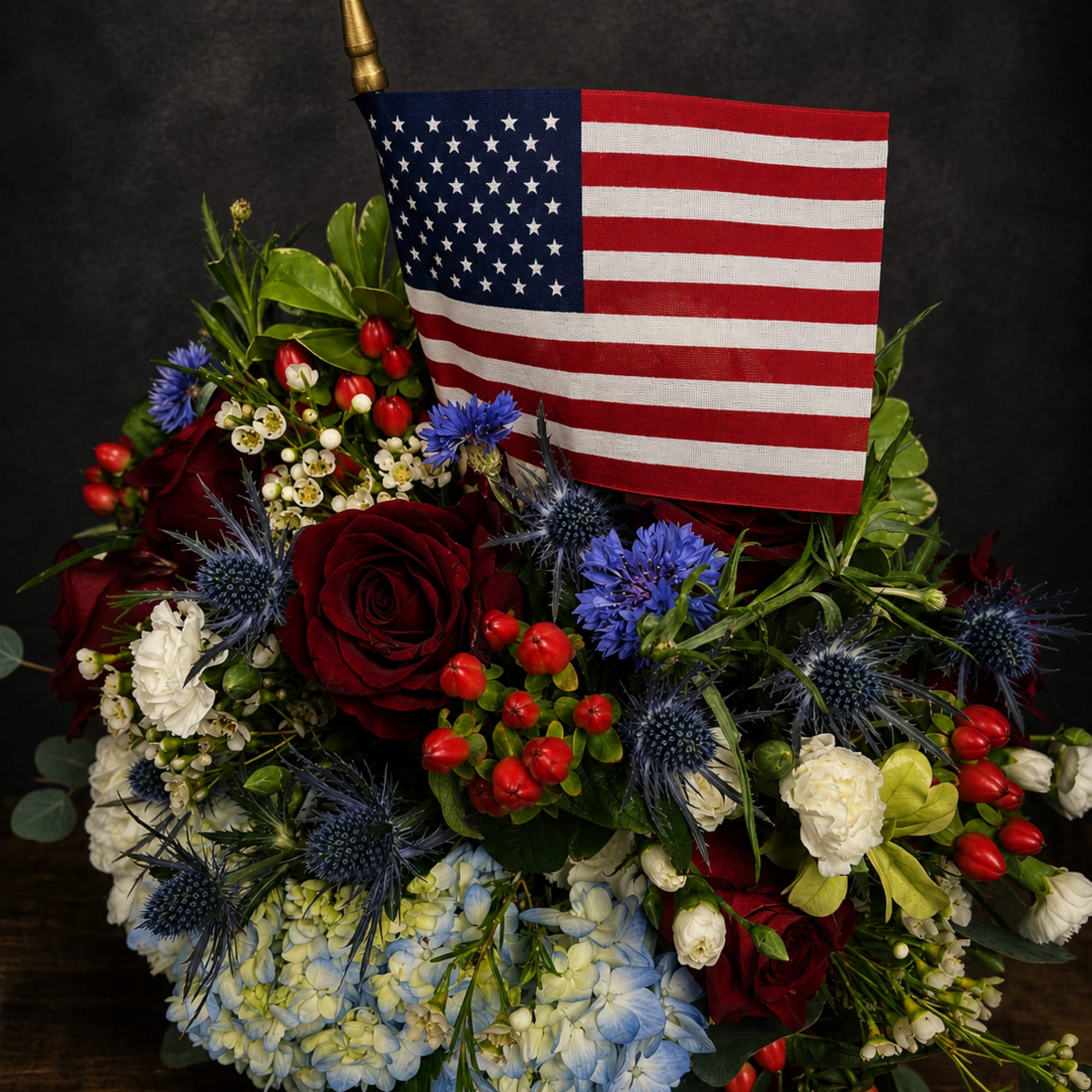 Bright, patriotic and full-bodied, this red, white and blue flower arrangement is